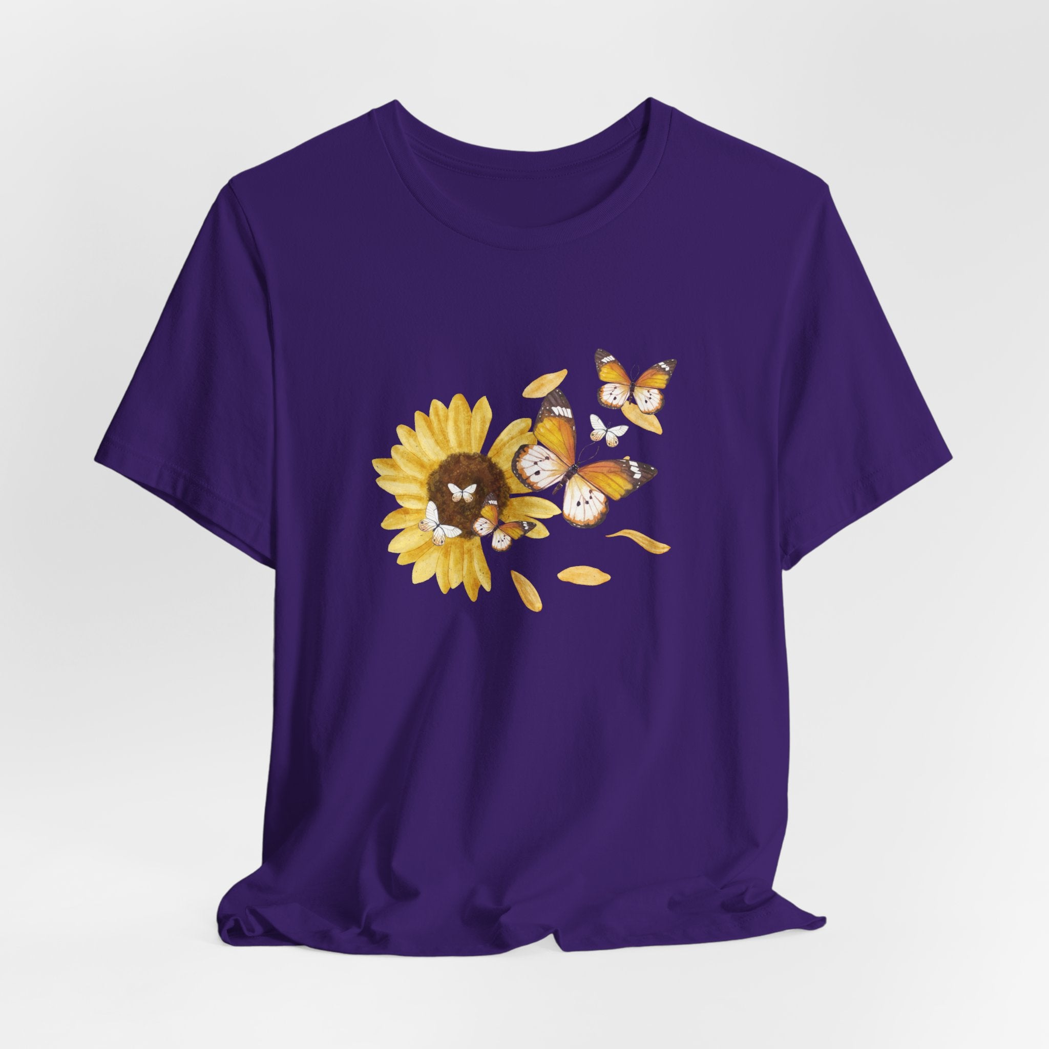 Purple t-shirt with a sunflower and butterfly design on a white background