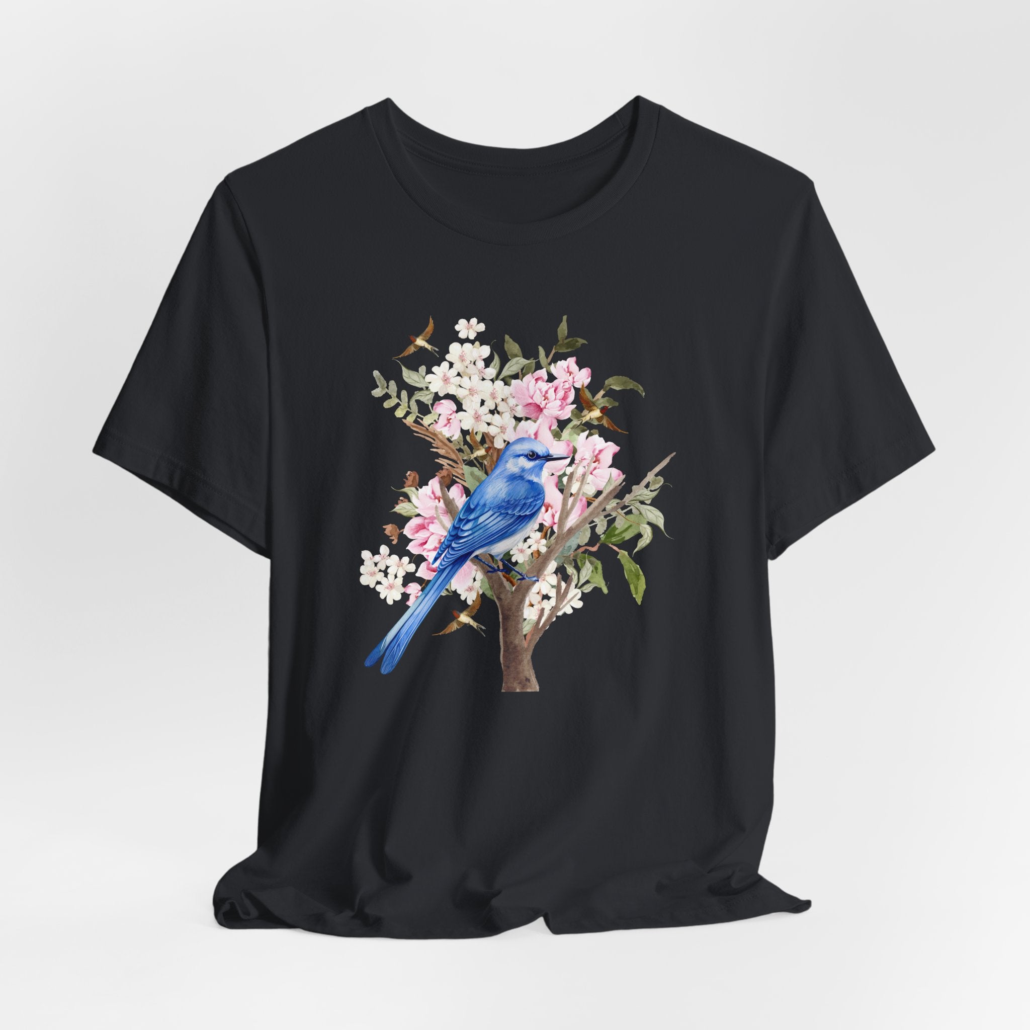 Black t-shirt with a blue bird and floral design on a white background