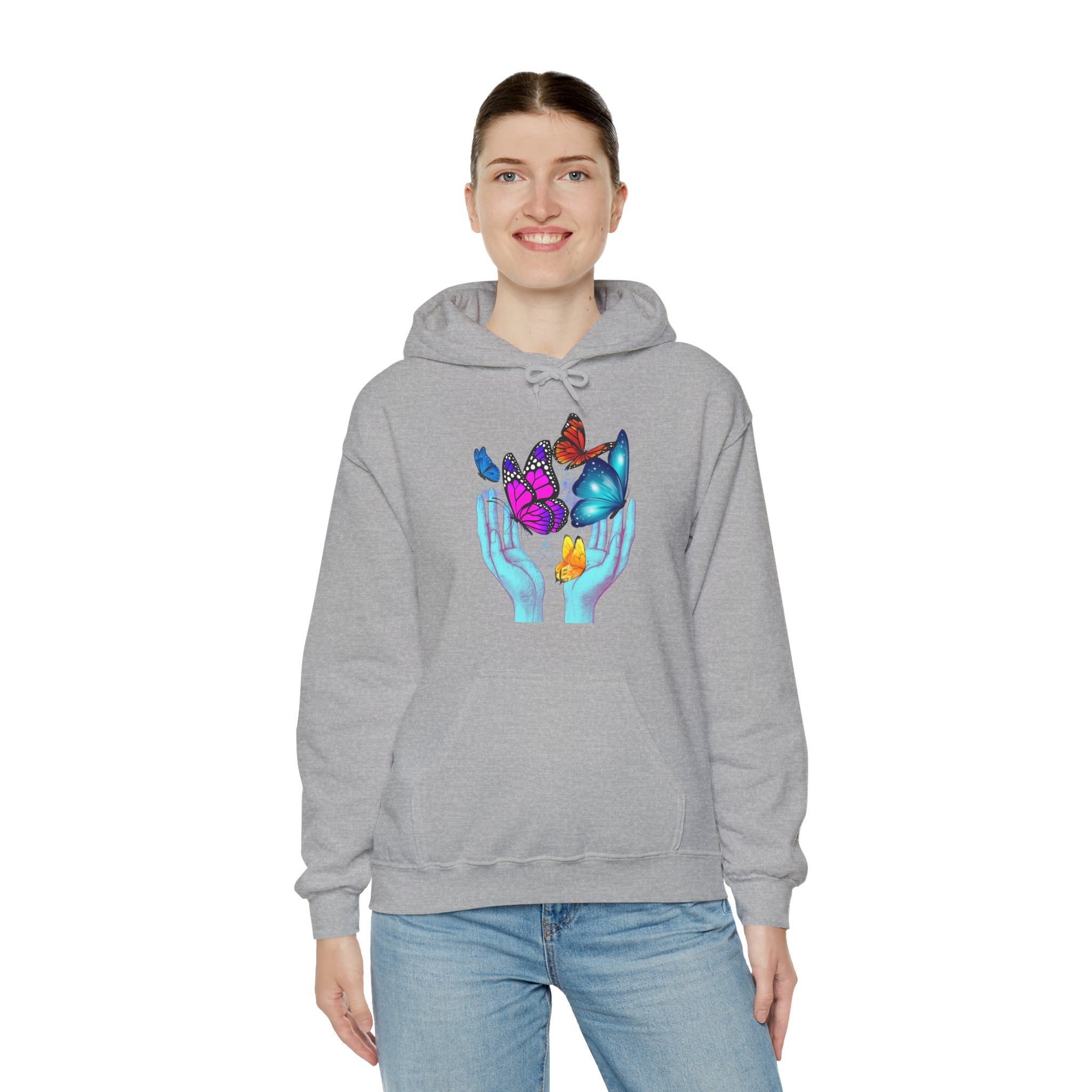 Person wearing a gray hoodie with a graphic of hands holding flowers and butterflies on a white background