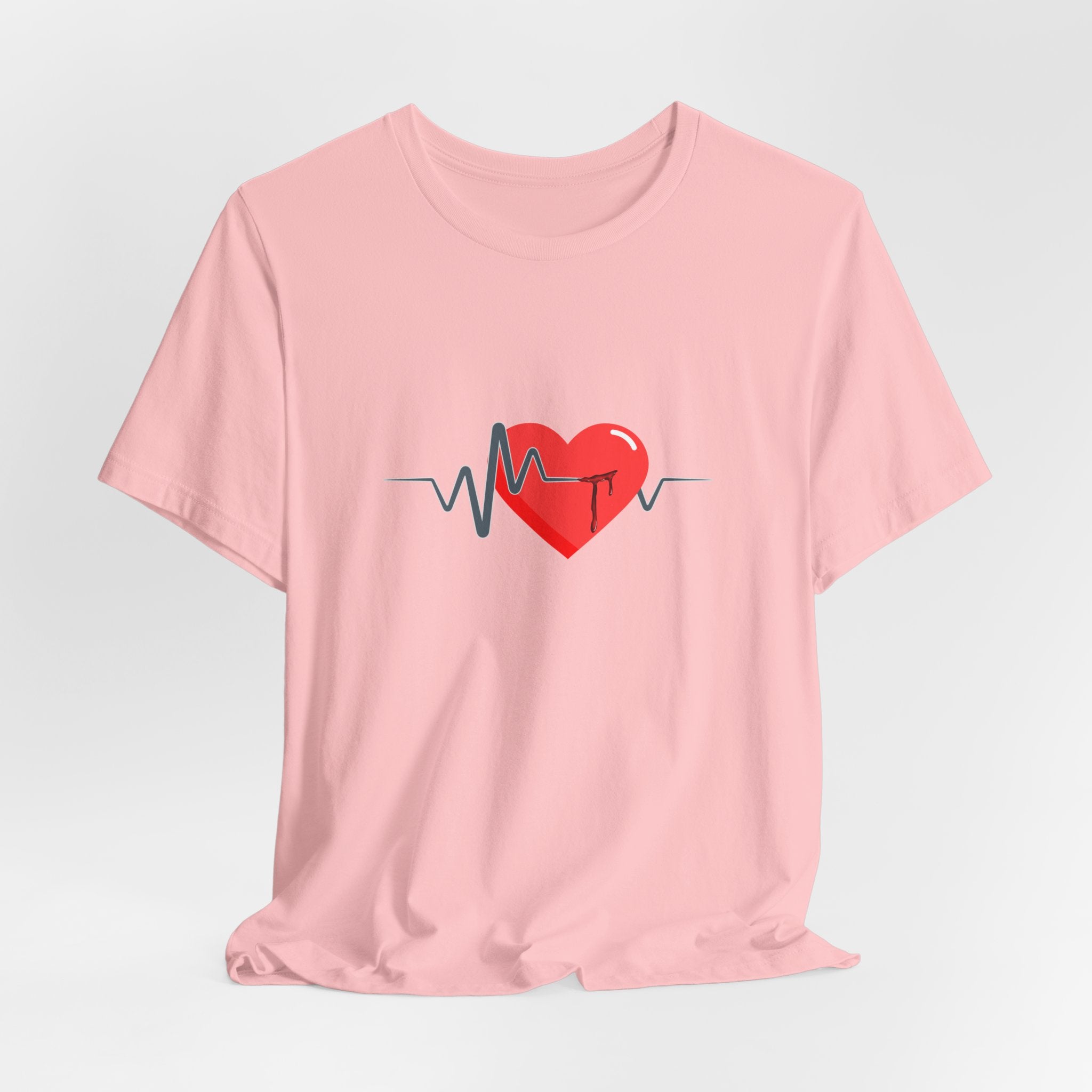 Pink t-shirt with a red heart and heartbeat line design on a light gray background