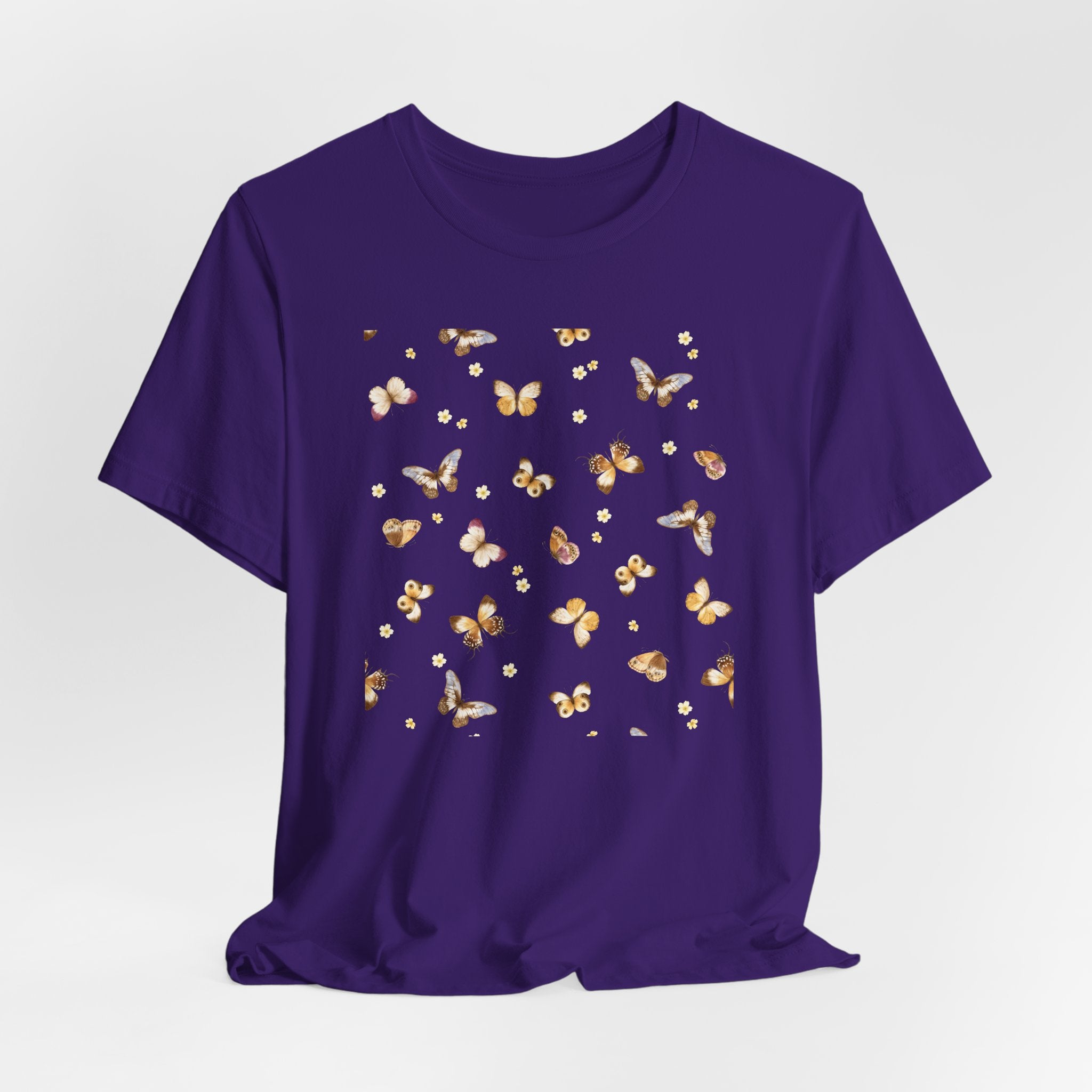 Purple t-shirt with butterfly pattern on a light gray background