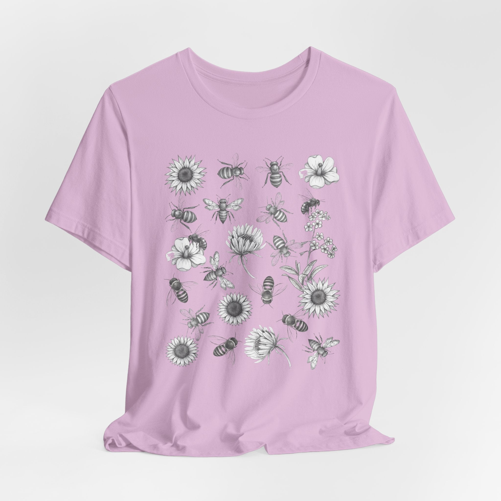 Light purple t-shirt with bee and flower pattern on a light gray background