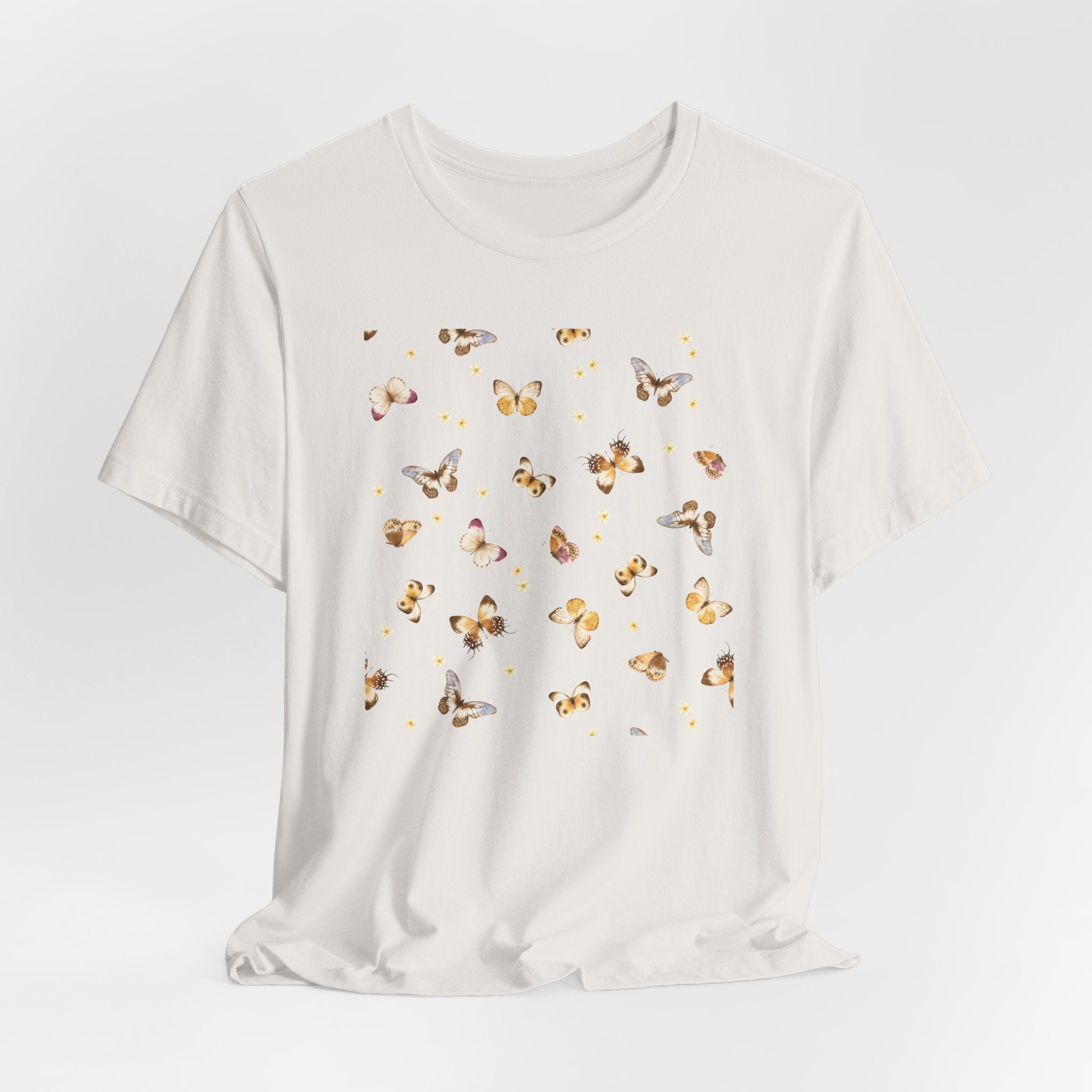 White t-shirt with butterfly pattern on a light gray background