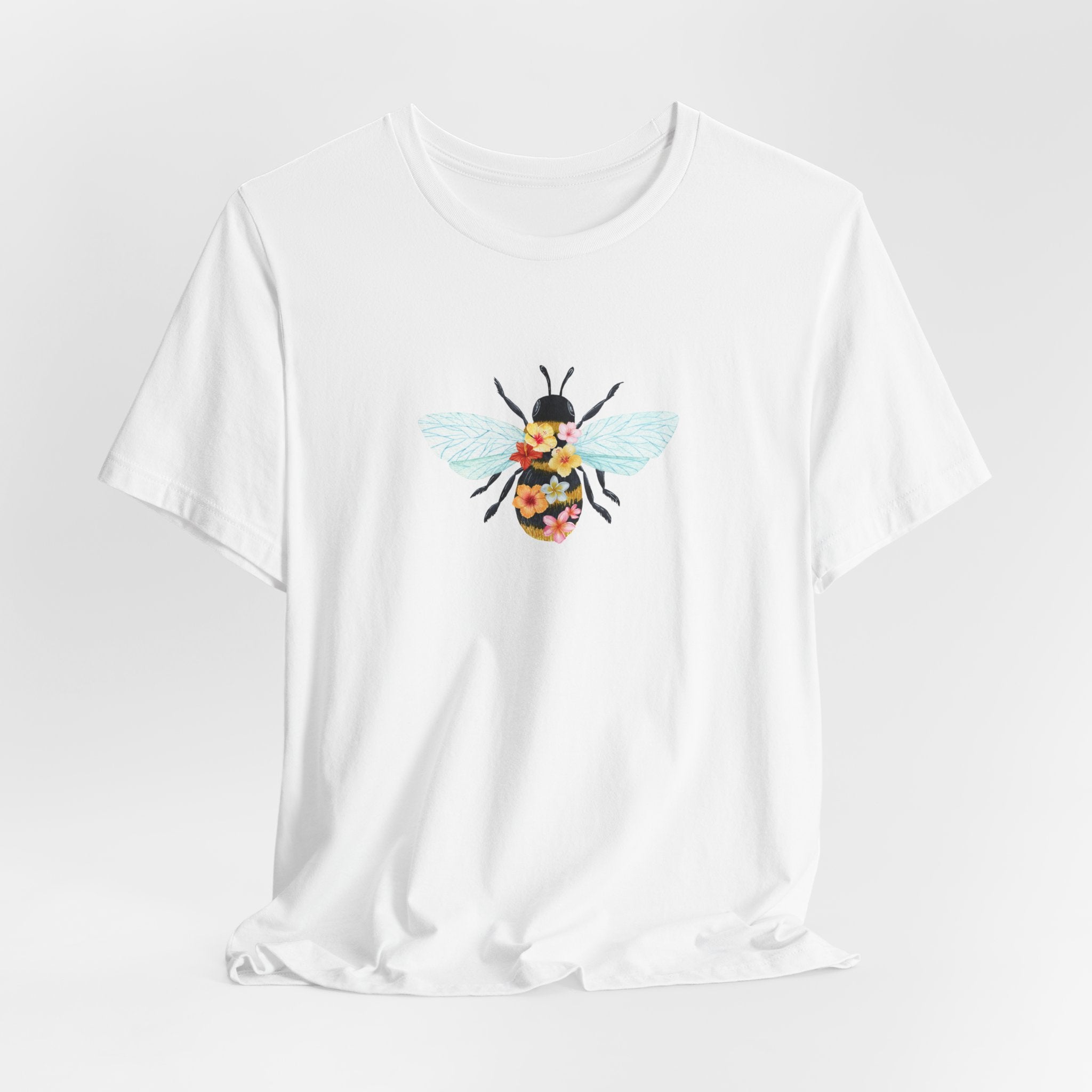 White t-shirt with a bee graphic on a light gray background