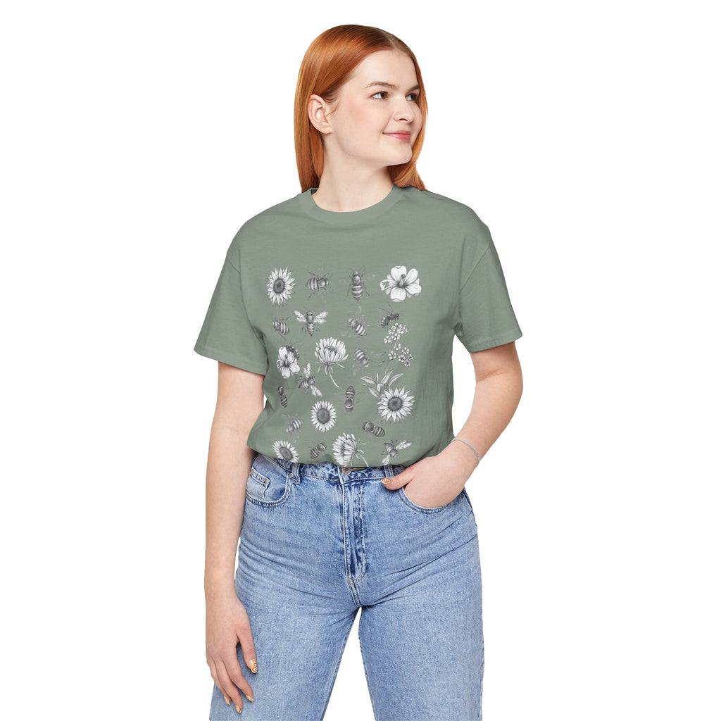 Person wearing a green t-shirt with floral designs and blue jeans on a white background