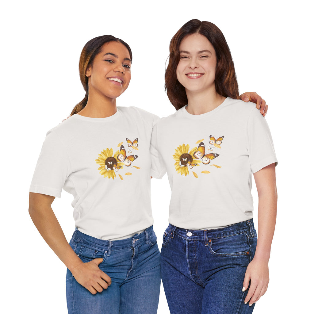 Persons wearing a beige t-shirt with a sunflower design on a white background