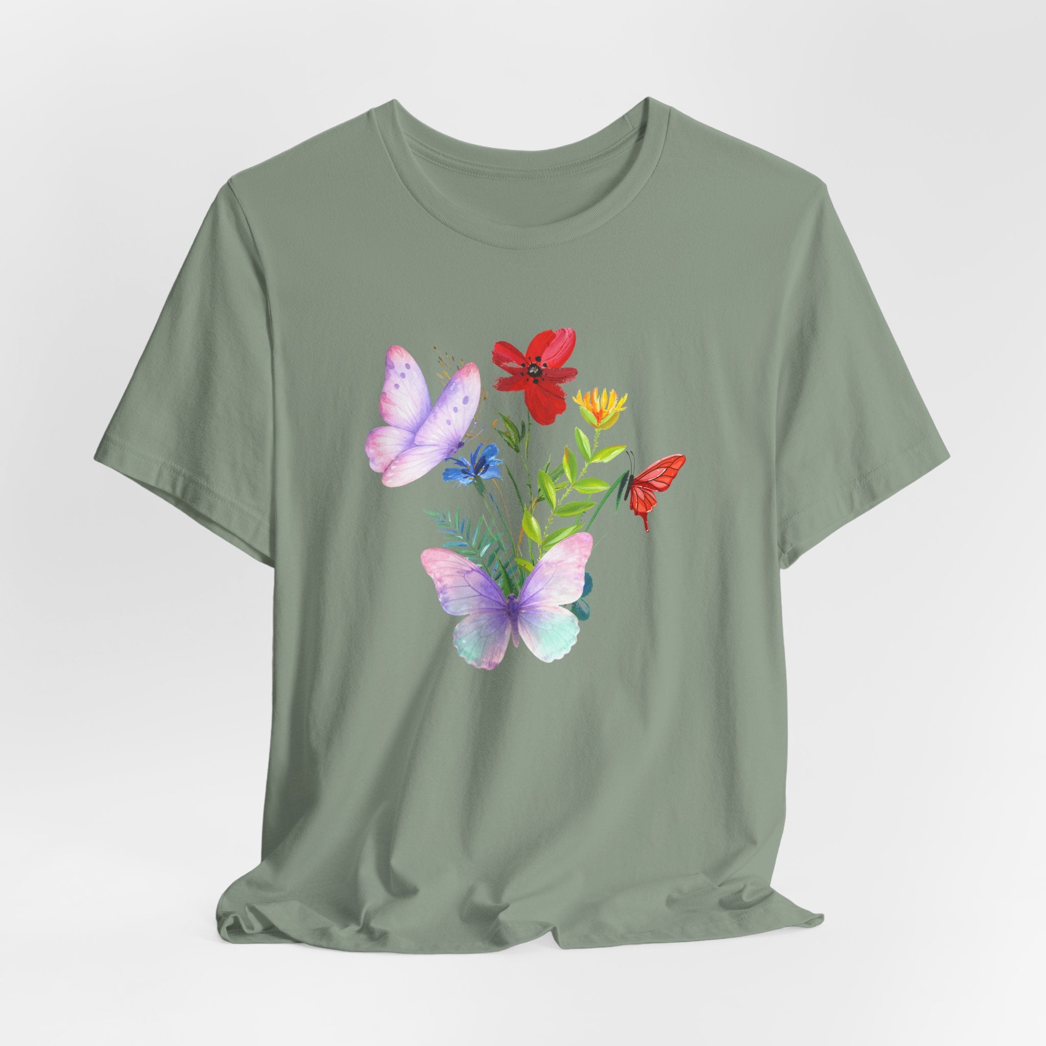Green t-shirt with butterfly and flower design on a light gray background
