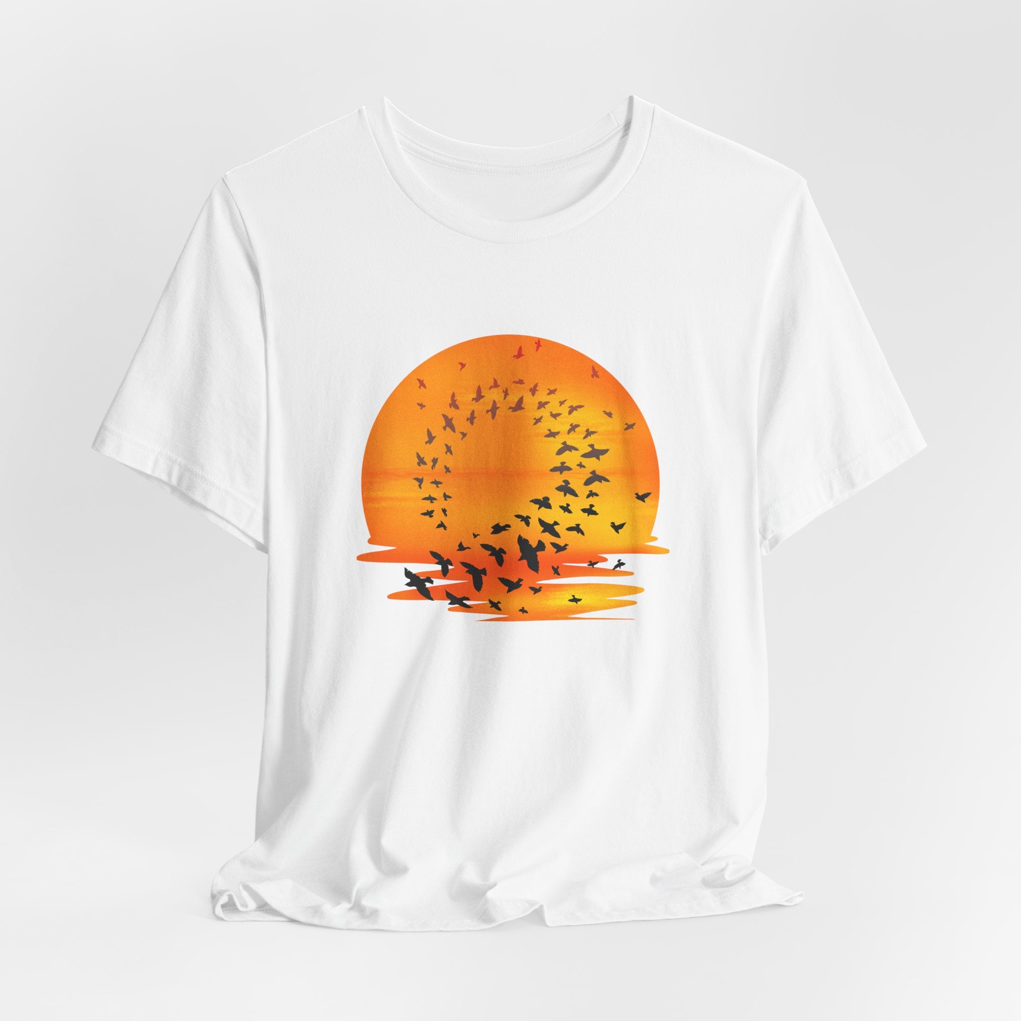 White t-shirt with a sunset and bird design on a white background