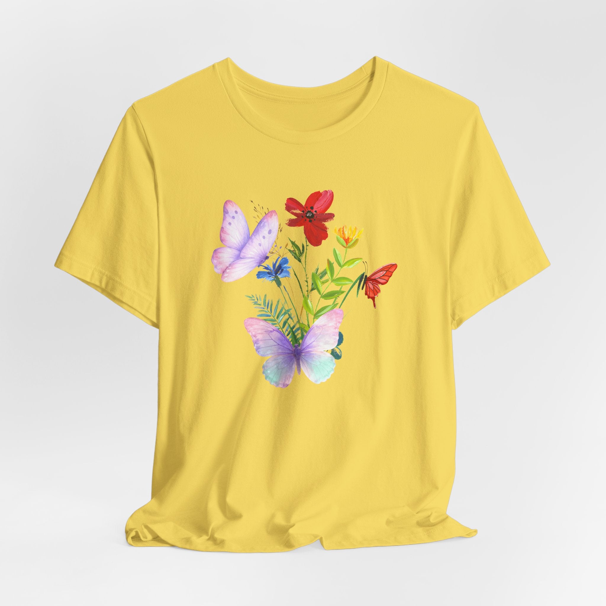 Yellow t-shirt with butterfly and flower design on a light gray background