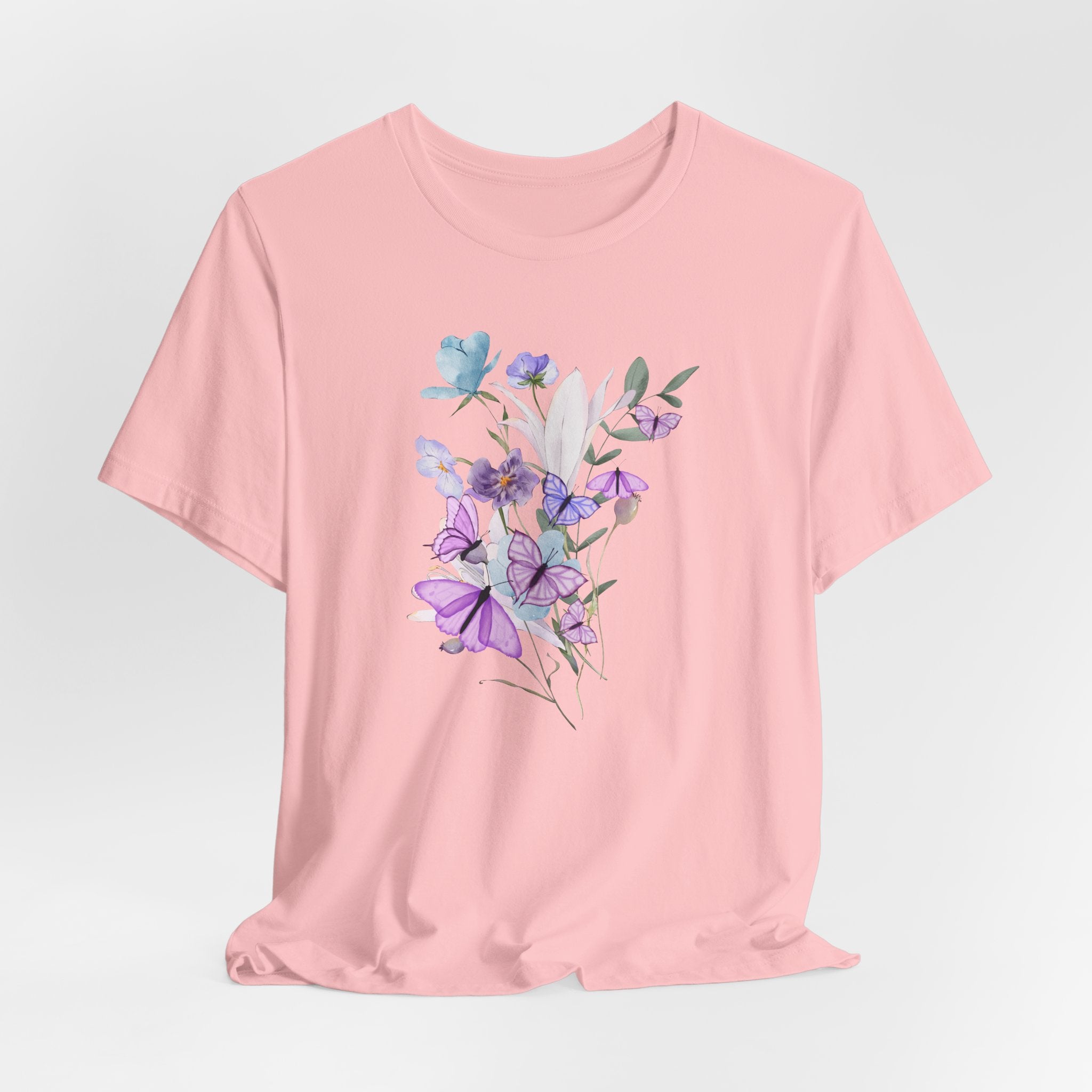 Pink t-shirt with floral design on a light gray background