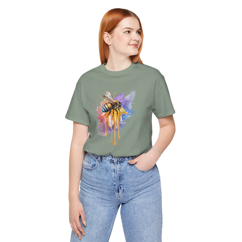 Person wearing a green t-shirt with a colorful bee design on a white background