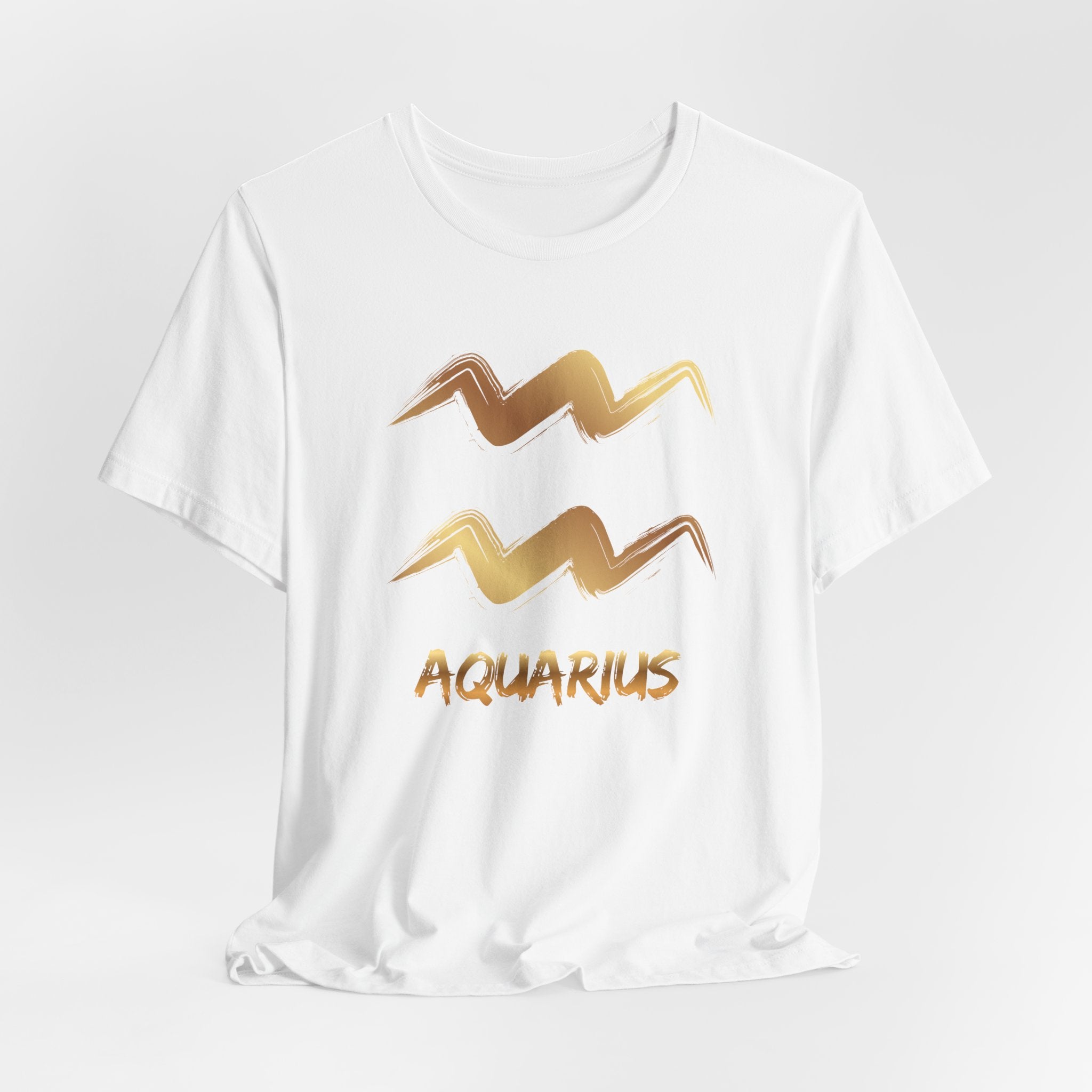 White t-shirt with gold Aquarius zodiac sign design on a light gray background