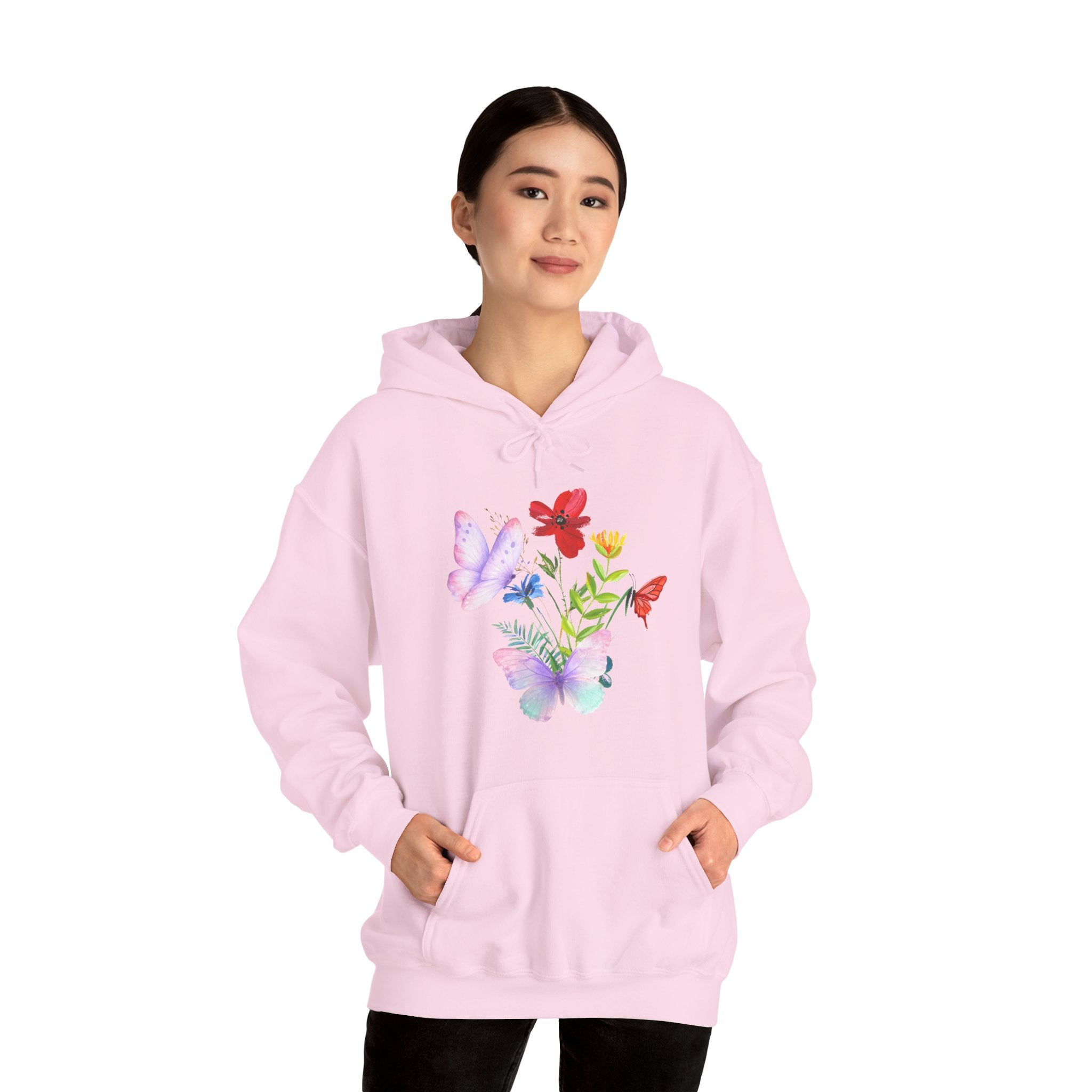 Person wearing a pink hoodie with colorful butterfly designs on a white background