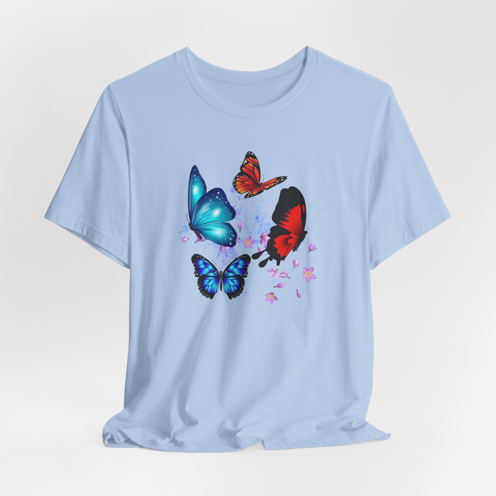 Light blue t-shirt with colorful butterfly designs on a light gray background