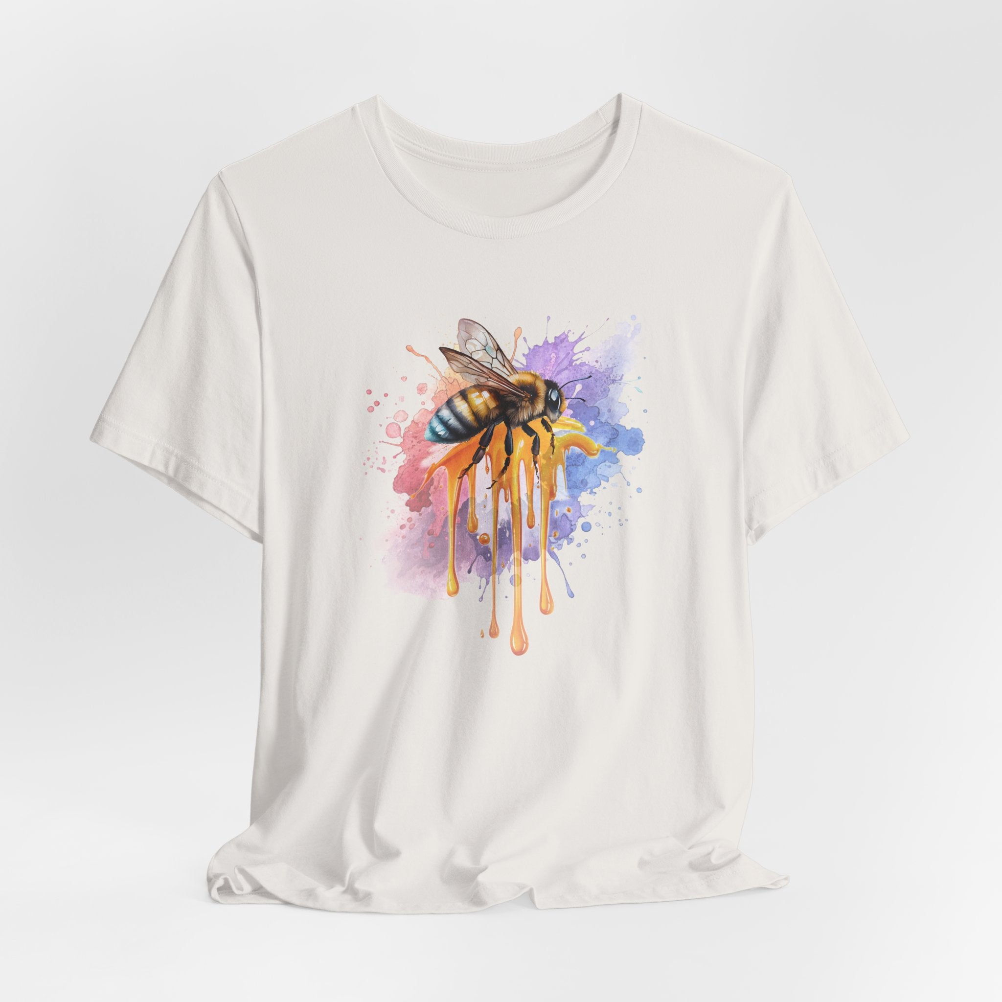 White t-shirt with a colorful bee design on a white background