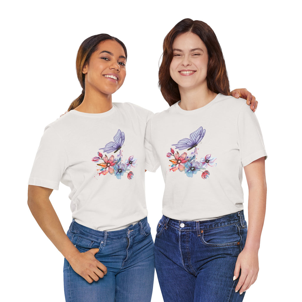 Two women wearing matching beige t-shirts with a colorful butterfly and flower design on a light gray background