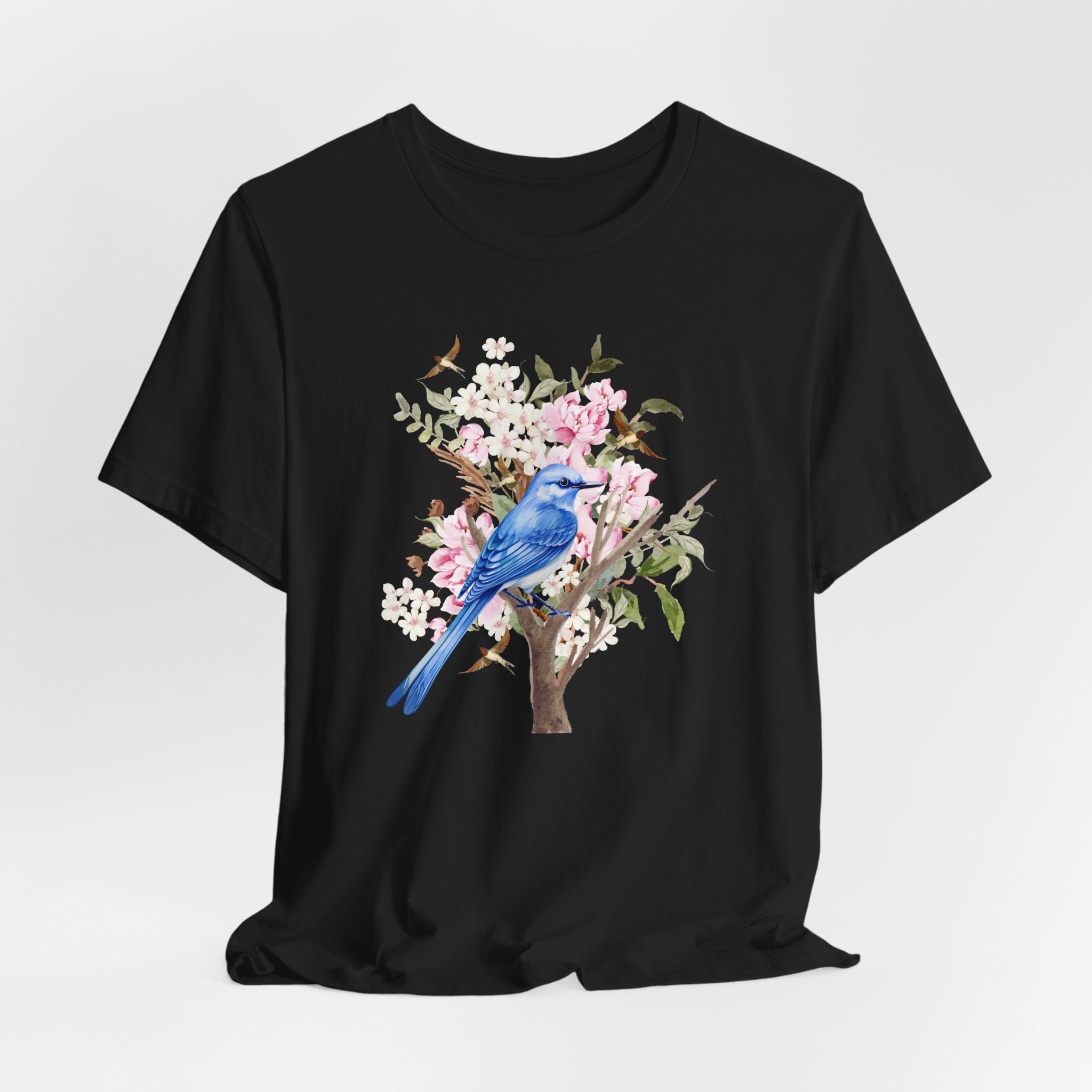 Black t-shirt with a blue bird and floral design on a white background