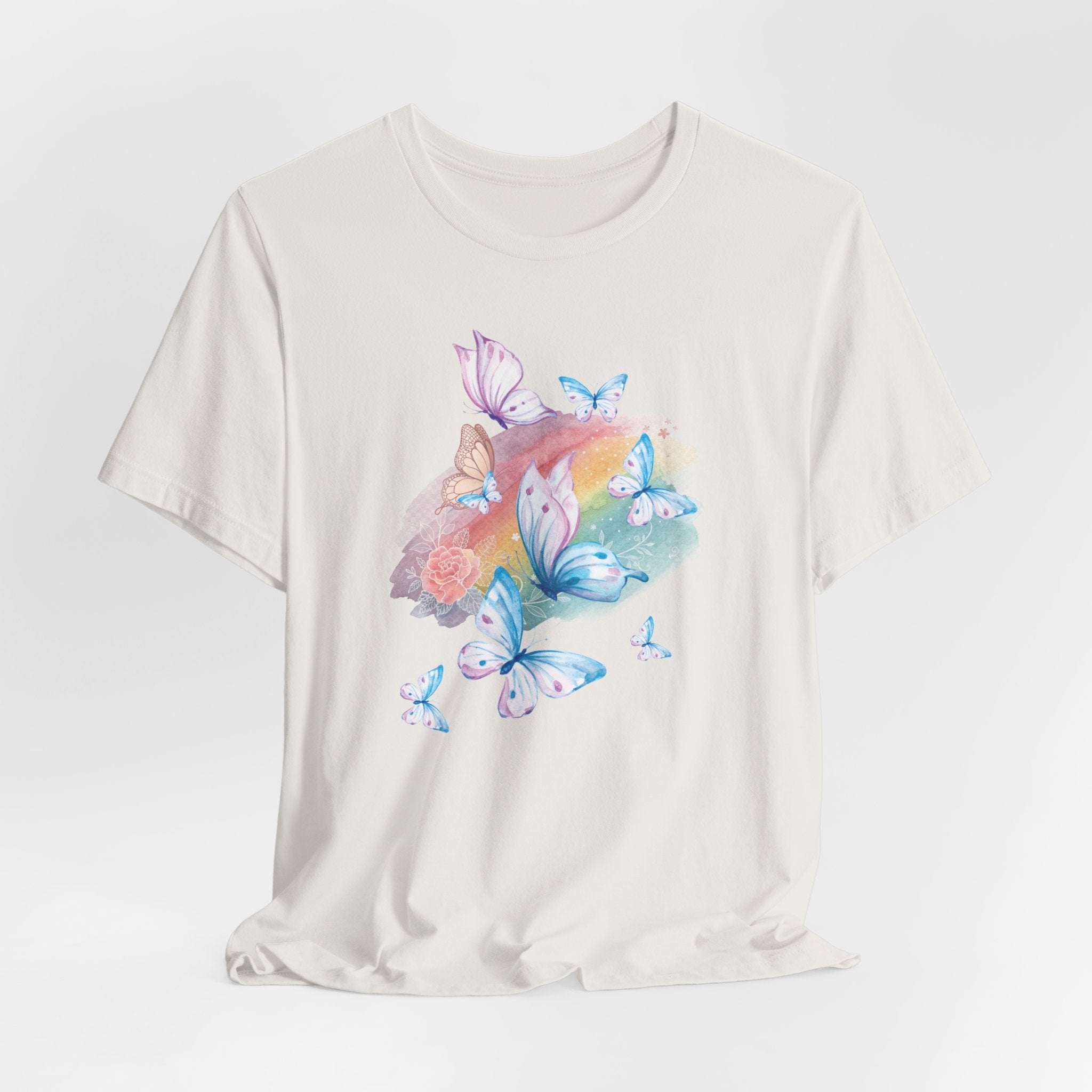 White t-shirt with colorful butterfly and flower design on a light gray background