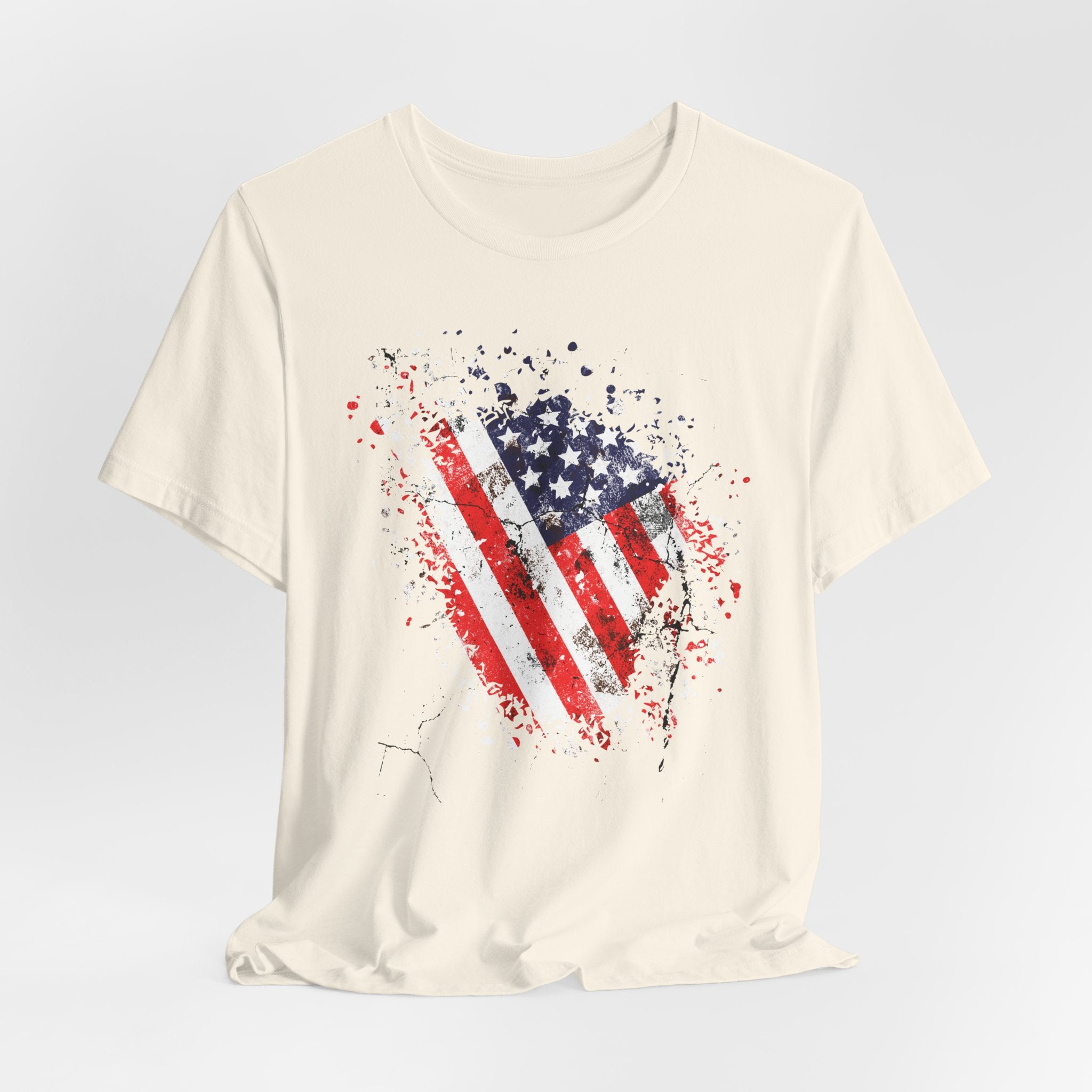 Beige t-shirt with American flag graphic on a light gray background
