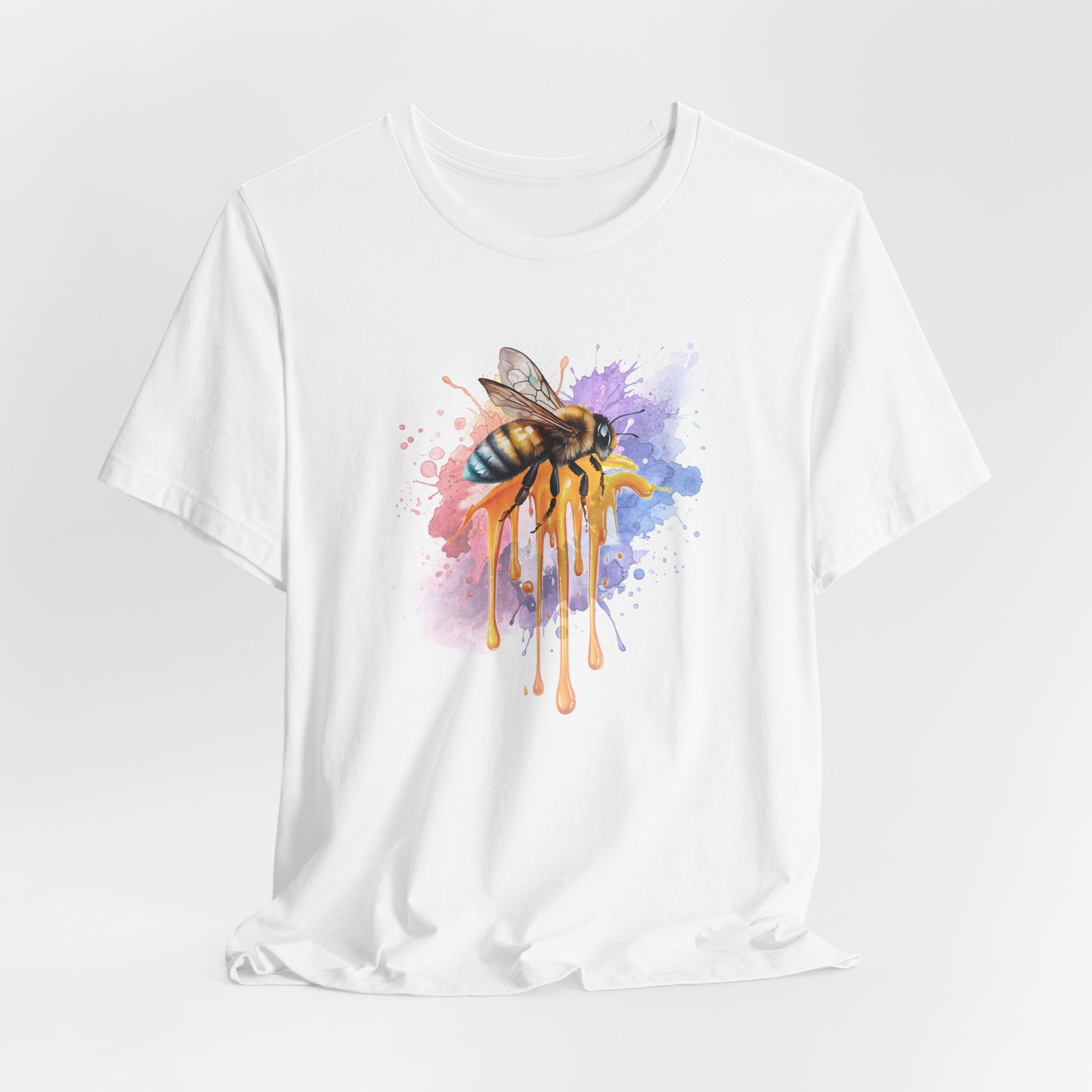 White t-shirt with a colorful bee design on a white background