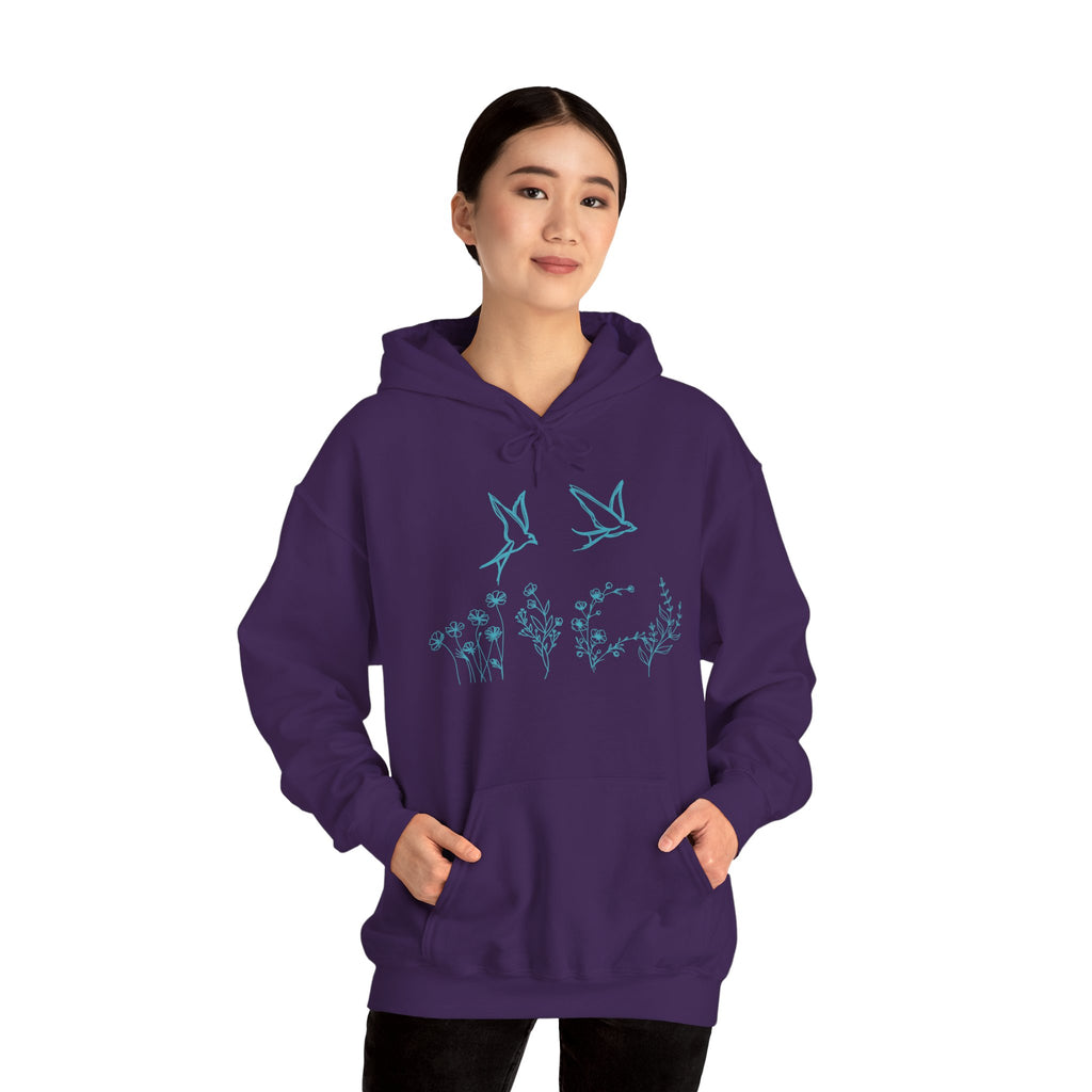 Person wearing a purple hoodie with a bird and flower graphics on a white background