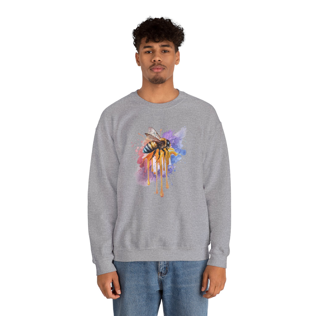 Person wearing a gray sweatshirt with a colorful bee design on a white background