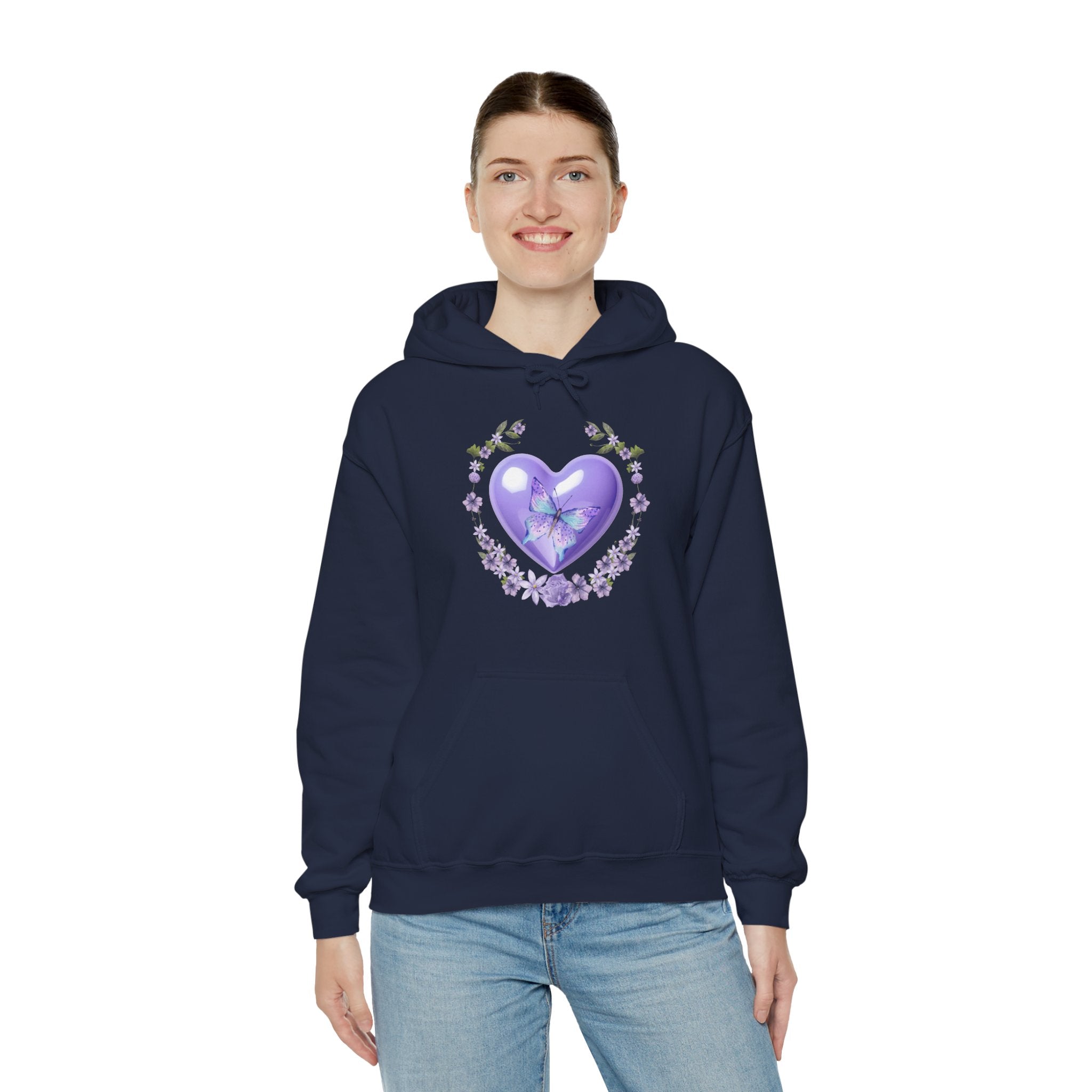 Person wearing a navy blue hoodie with a purple heart design on a white background