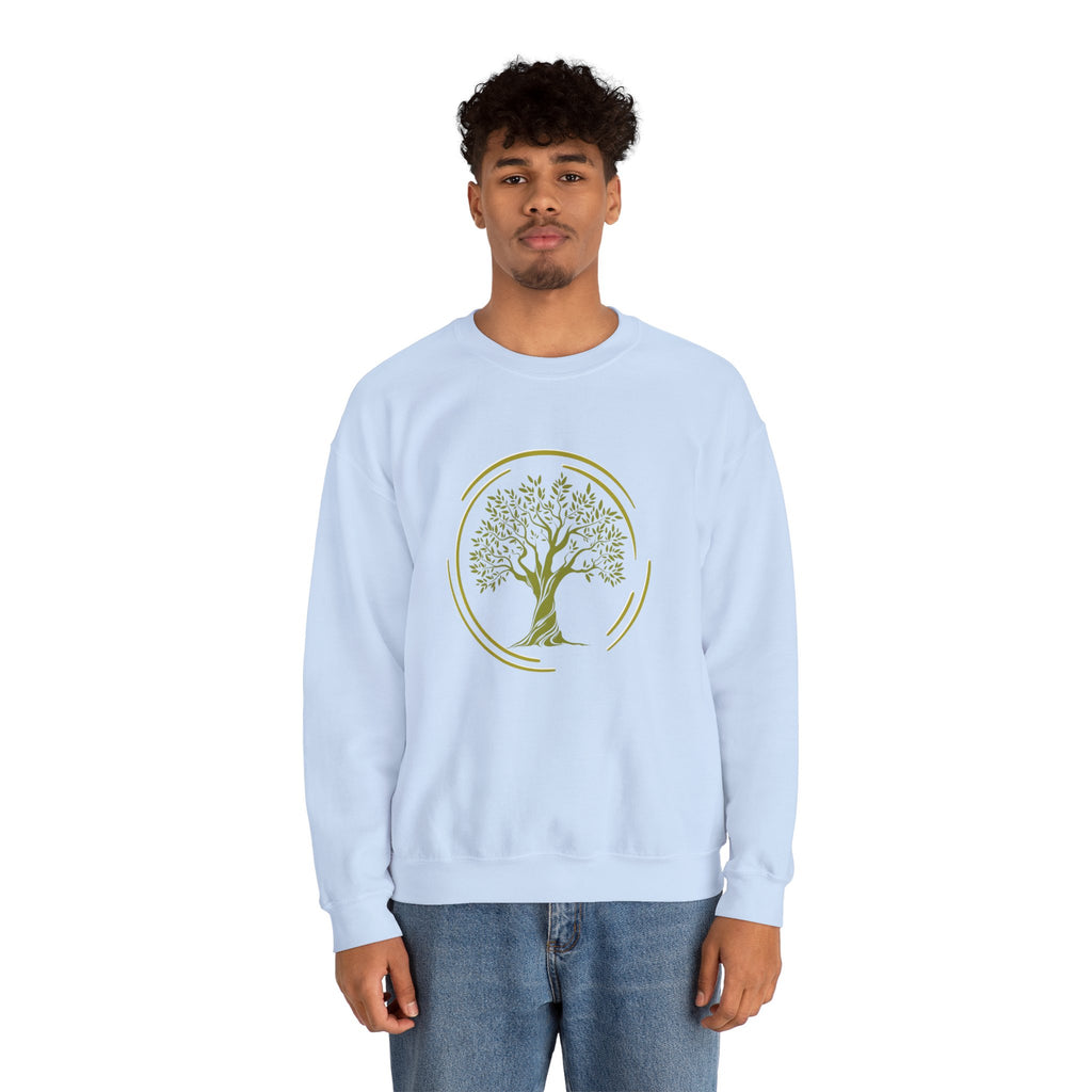 Person wearing a light blue sweatshirt with a tree design on a white background