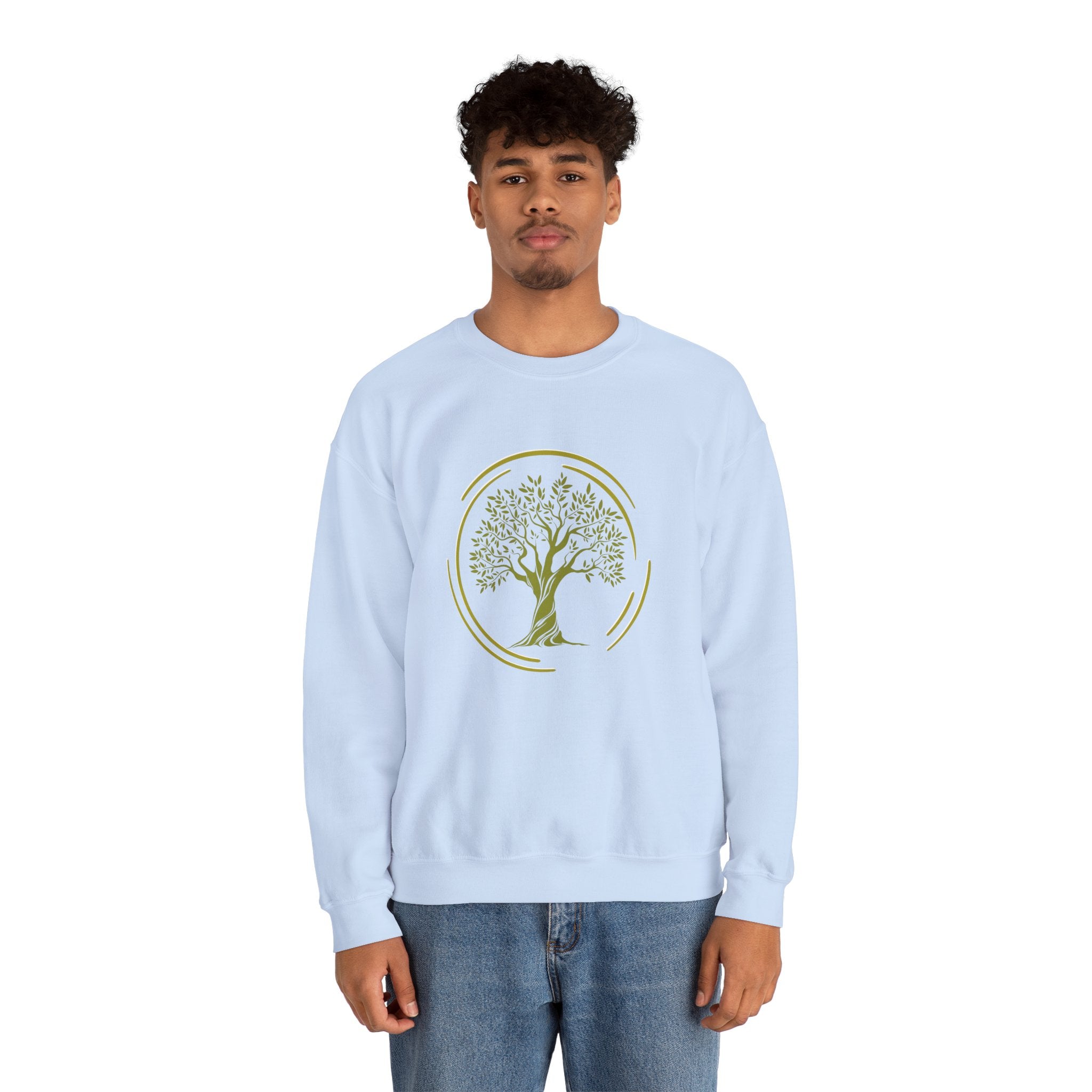 Person wearing a light blue sweatshirt with a tree design on a white background