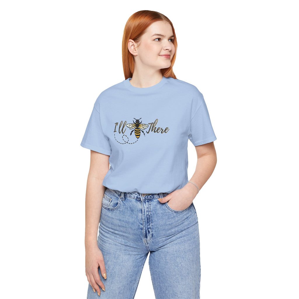Person wearing a light blue t-shirt with a bee graphic and text on a white background