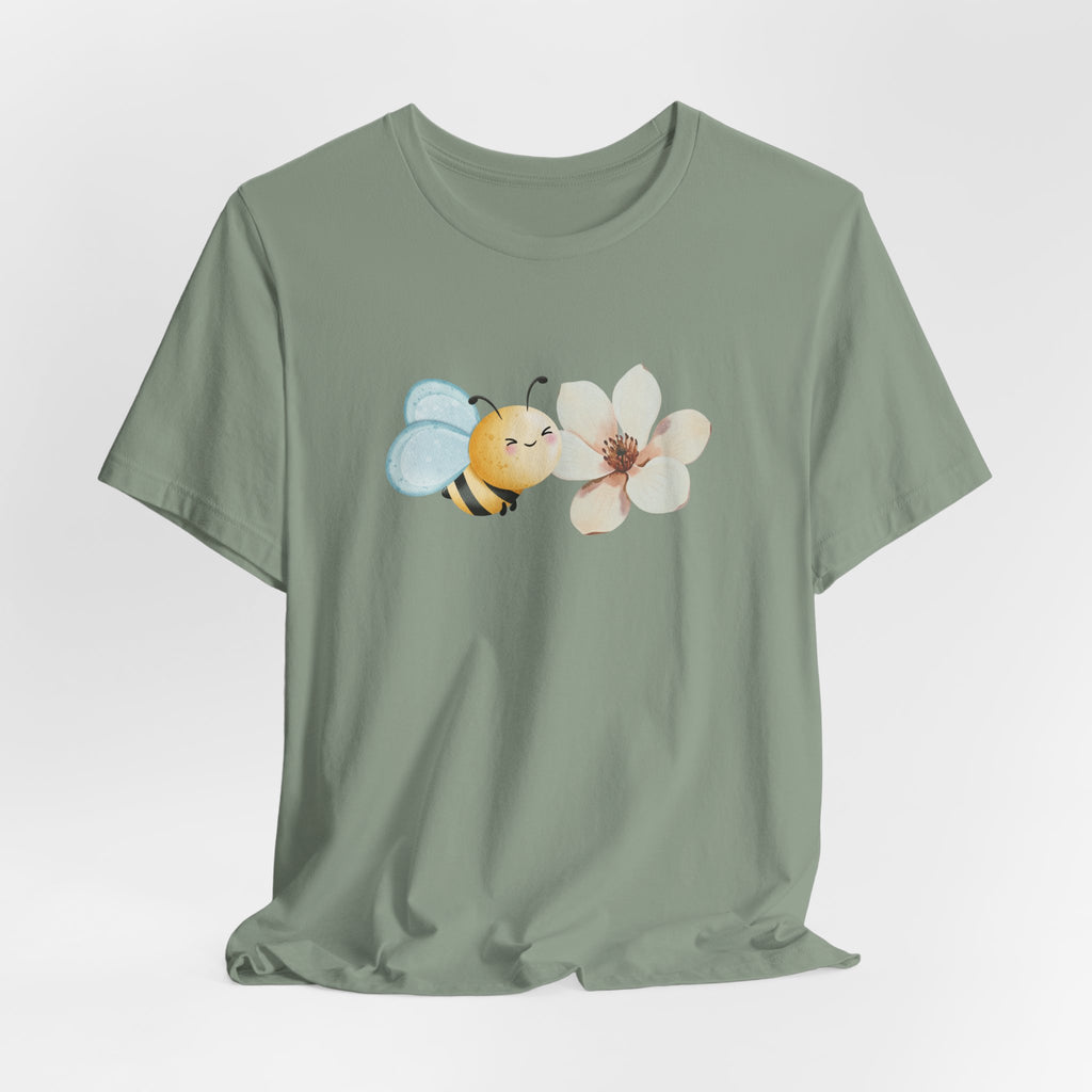 Green t-shirt with a bee and flower design on a light gray background