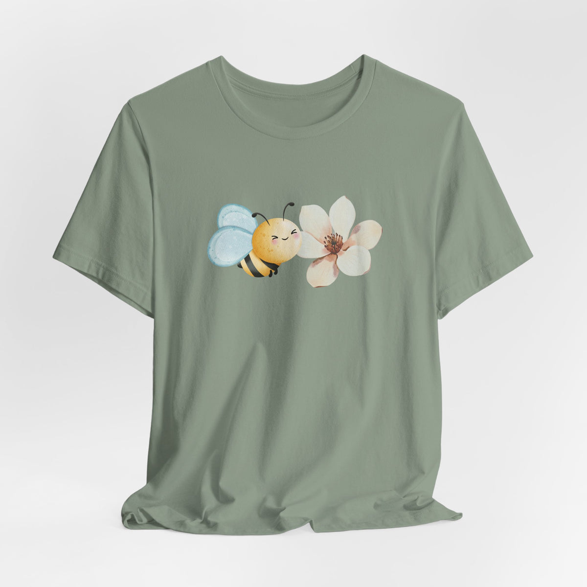Green t-shirt with a bee and flower design on a light gray background