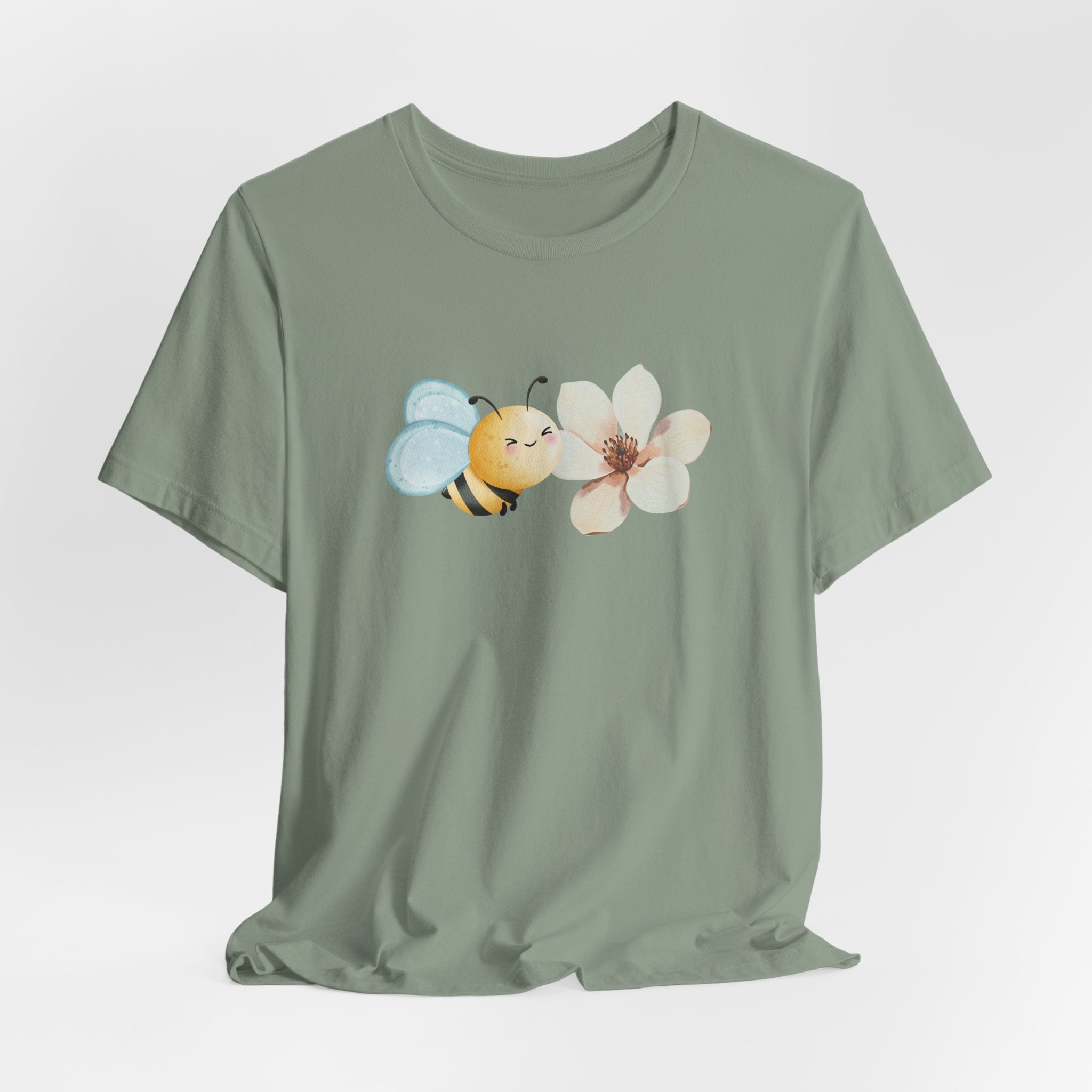 Green t-shirt with a bee and flower design on a light gray background