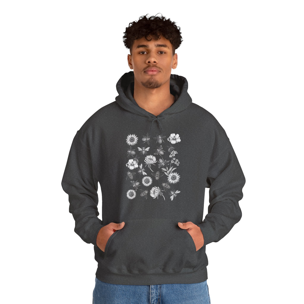 Person wearing a dark gray hoodie with floral and bee design on a white background