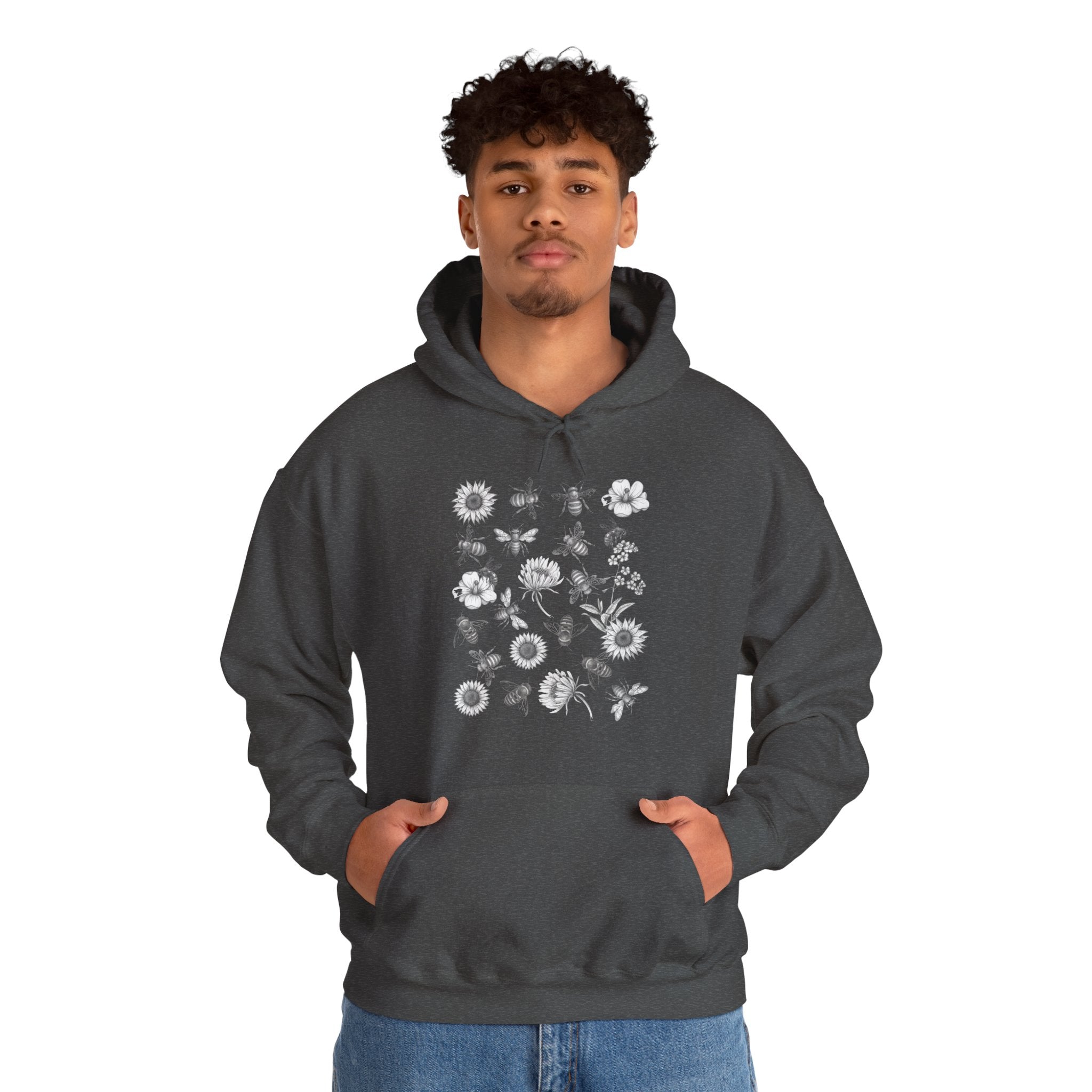 Person wearing a dark gray hoodie with floral and bee design on a white background