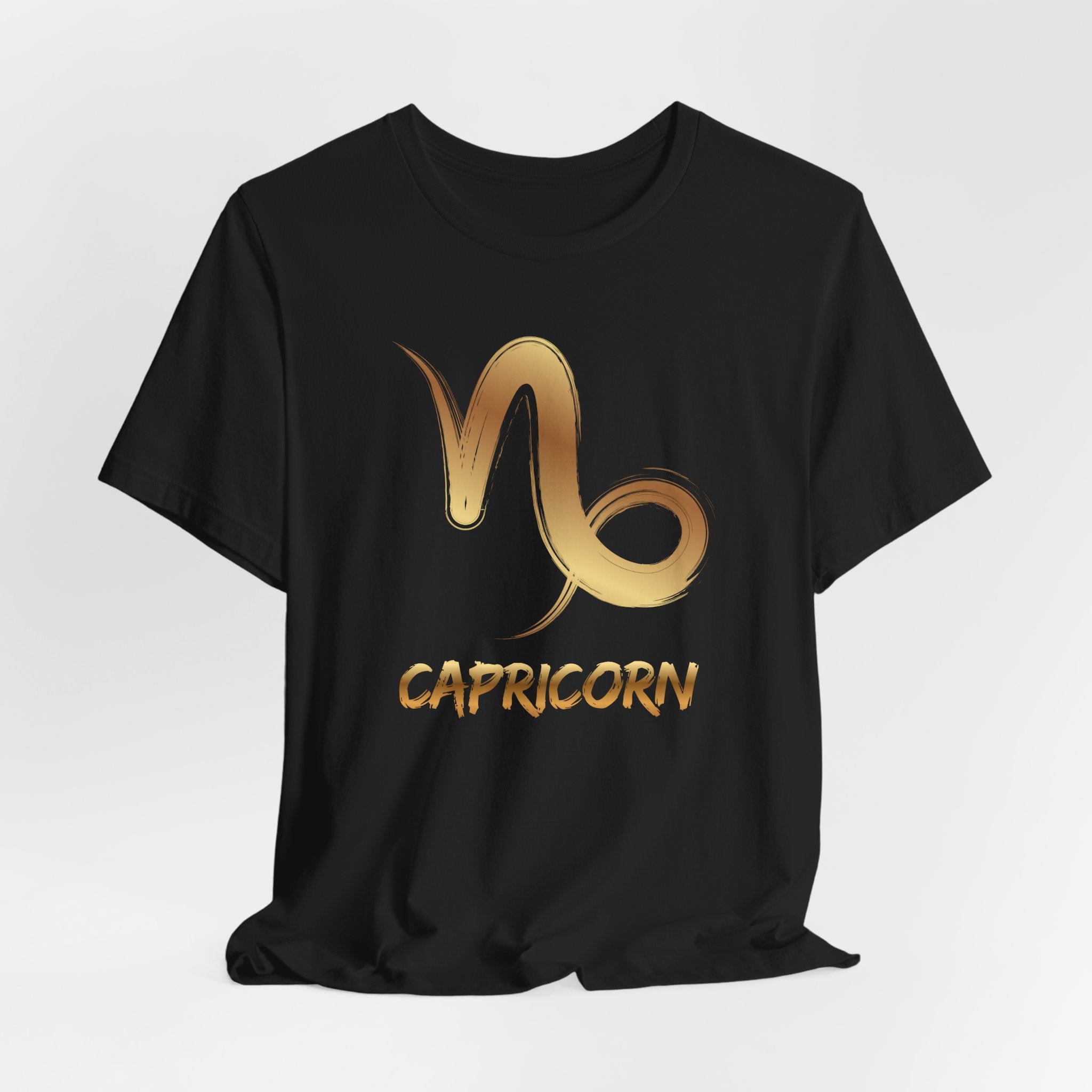 Black t-shirt with gold Capricorn zodiac symbol on a white background
