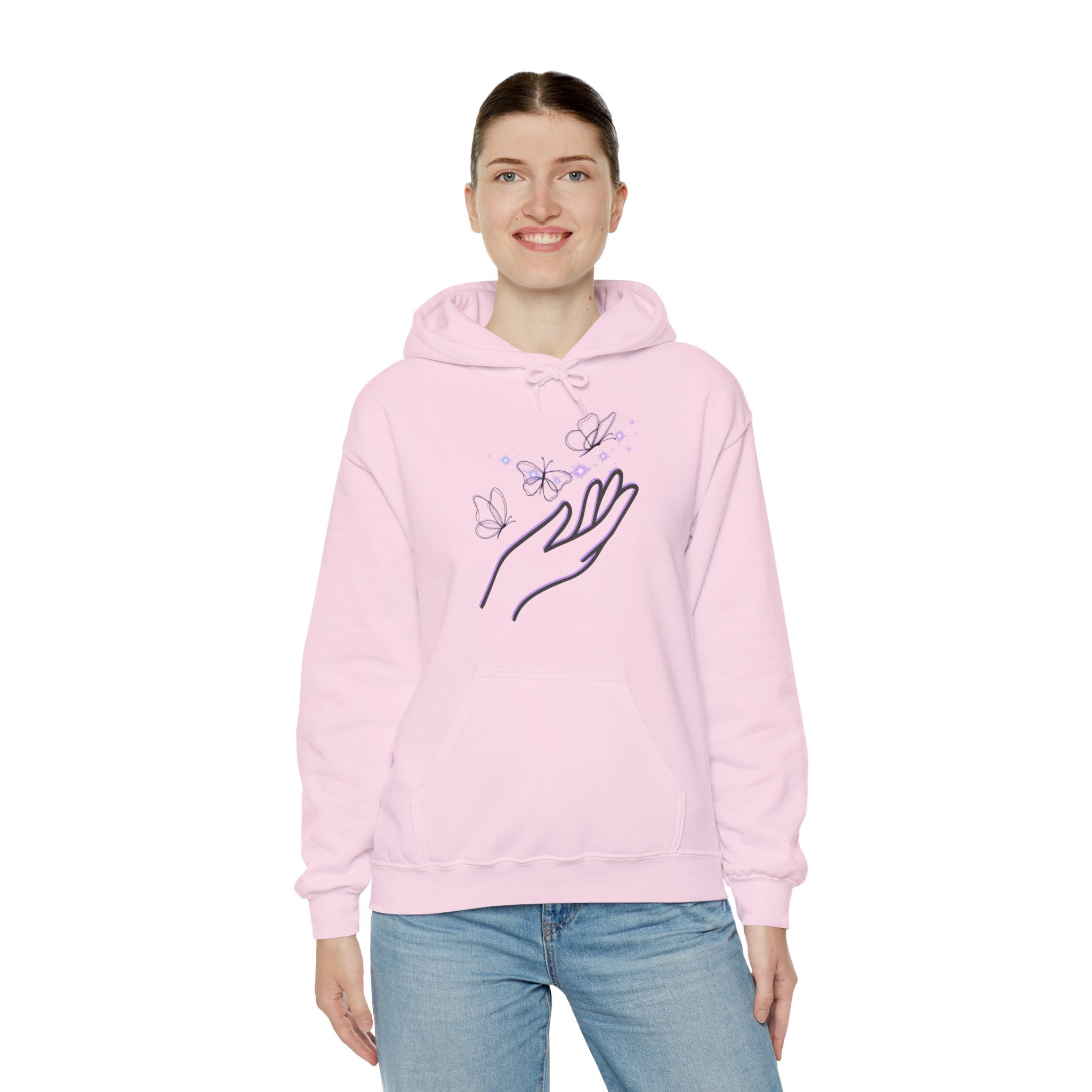 Person wearing a pink hoodie with a hand and butterfly design on a white background