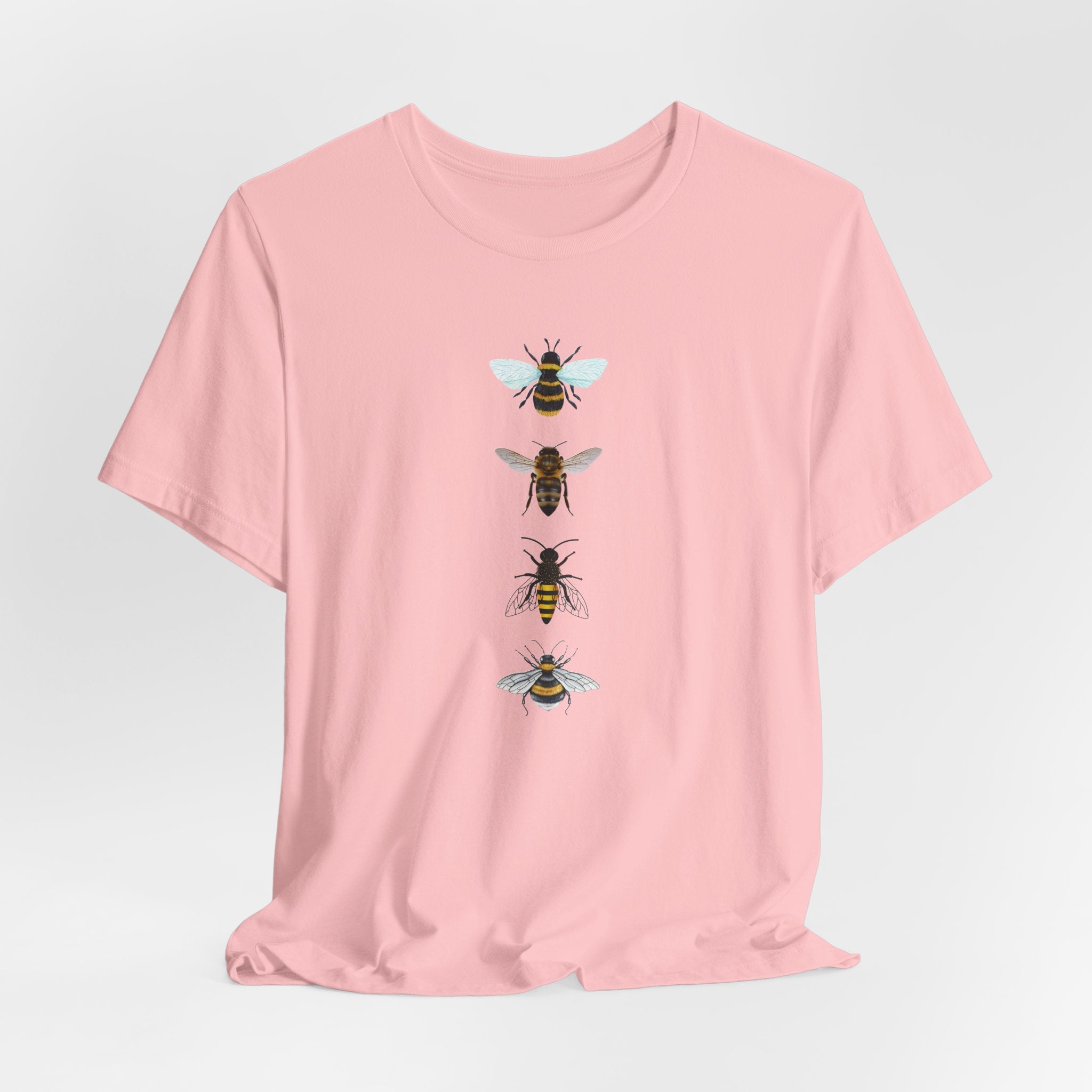 Pink t-shirt with bee illustrations on a light gray background