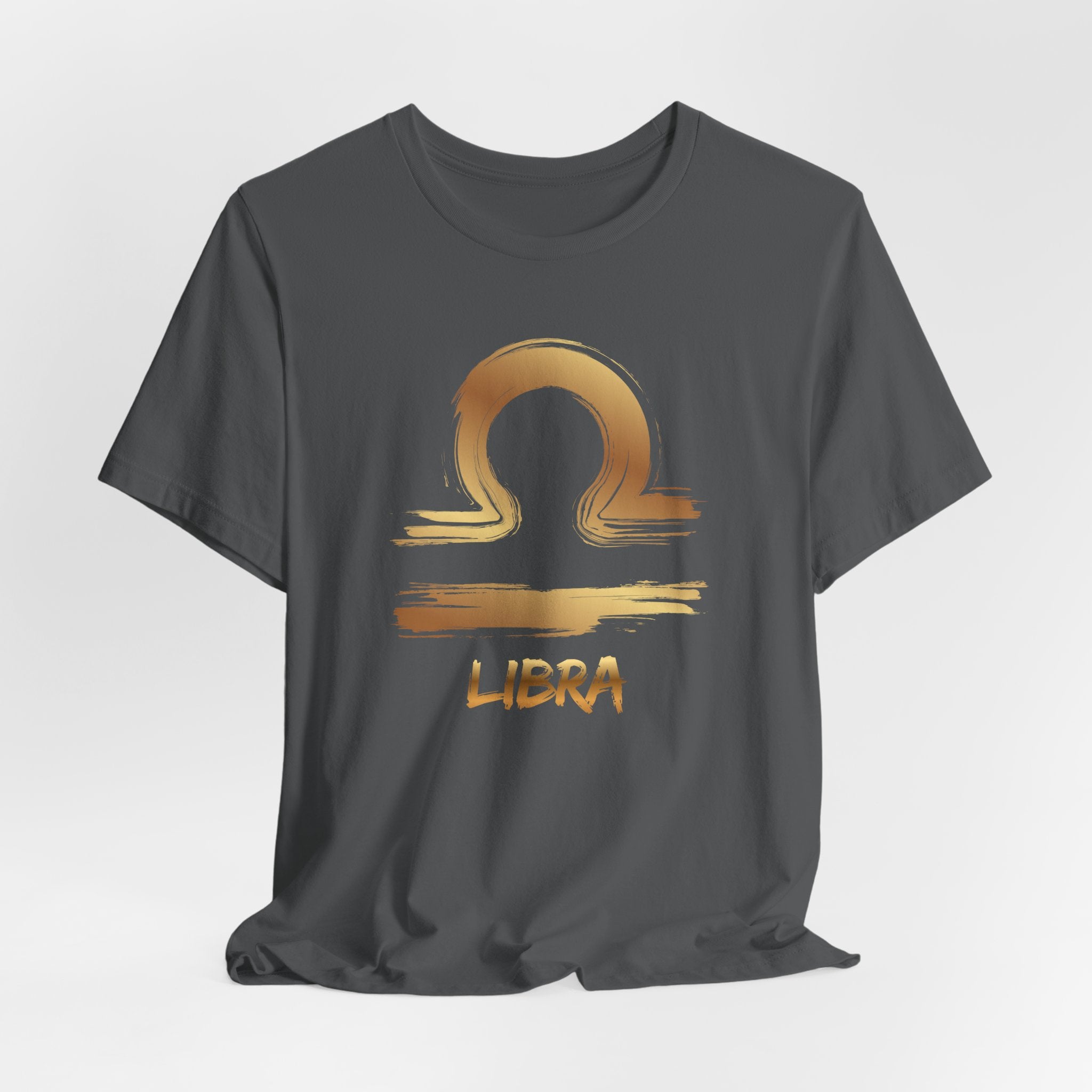 Gray t-shirt with gold Libra zodiac symbol on a light gray background