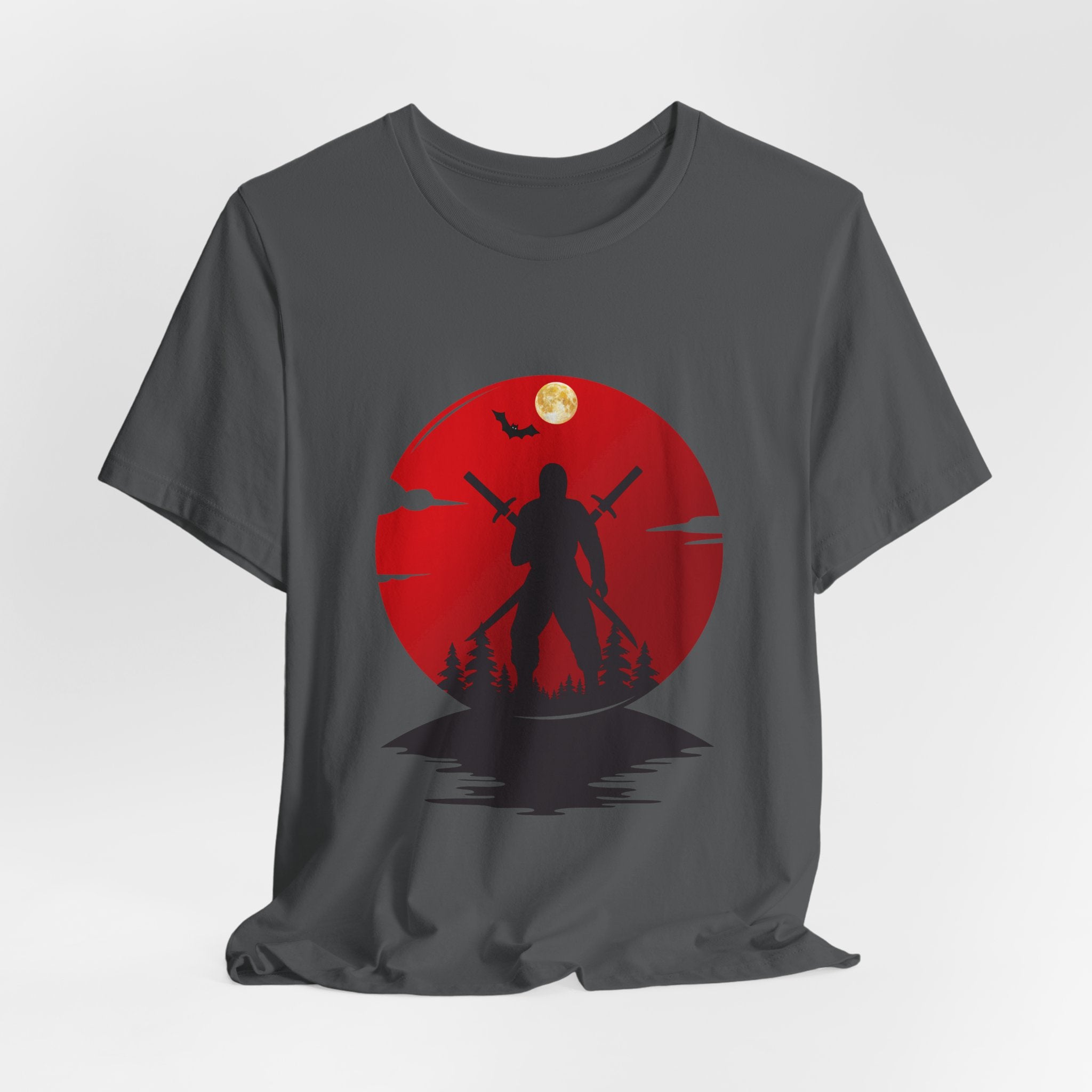 Gray t-shirt with a red graphic design featuring a silhouette of a person holding a spear against a moonlit sky.