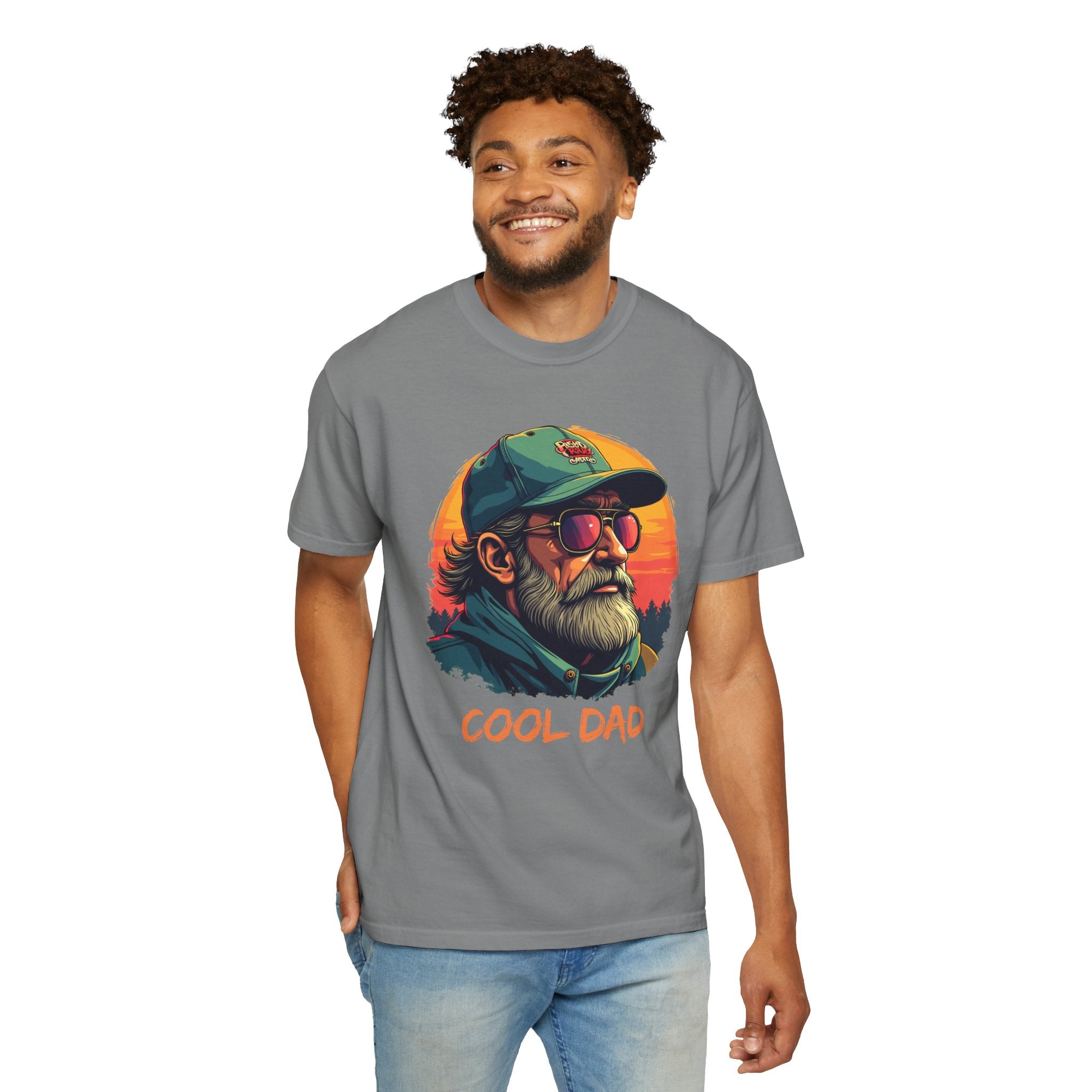 Man wearing a gray t-shirt with 'Cool Dad' graphic design featuring a man with sunglasses and a cap on a white background