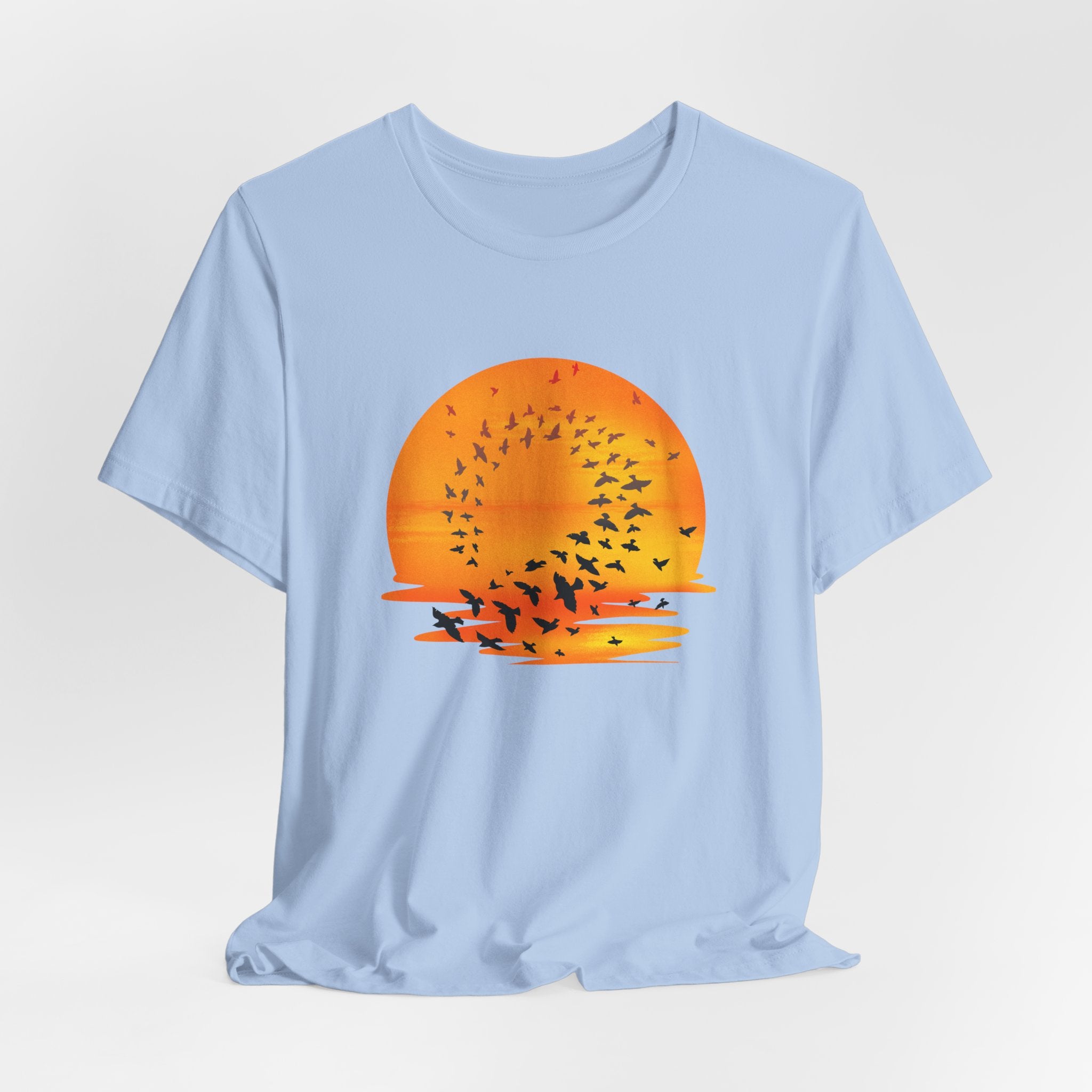 Light blue t-shirt with a sunset and bird design on a white background