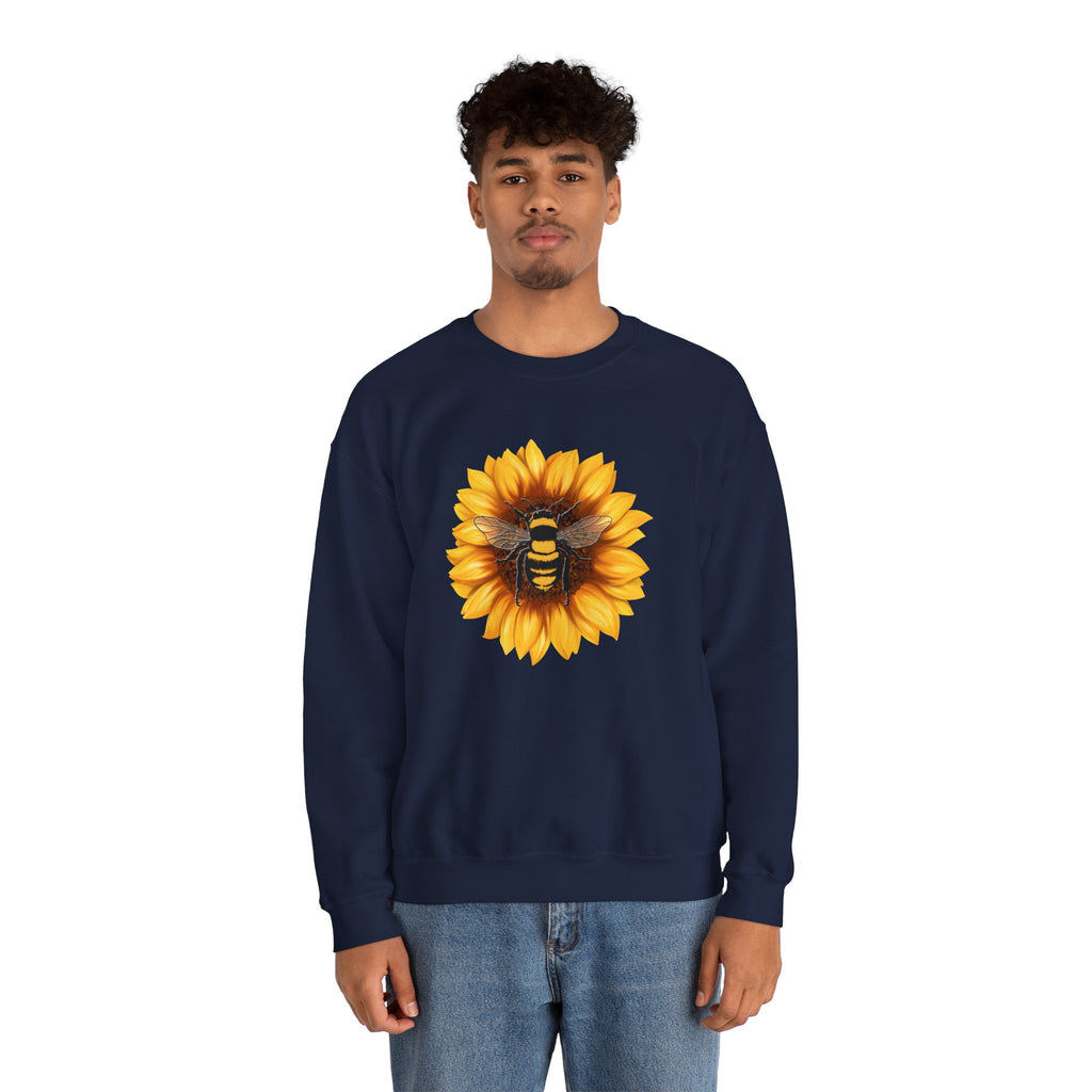 Person wearing a navy sweatshirt with a sunflower and bee design on a white background