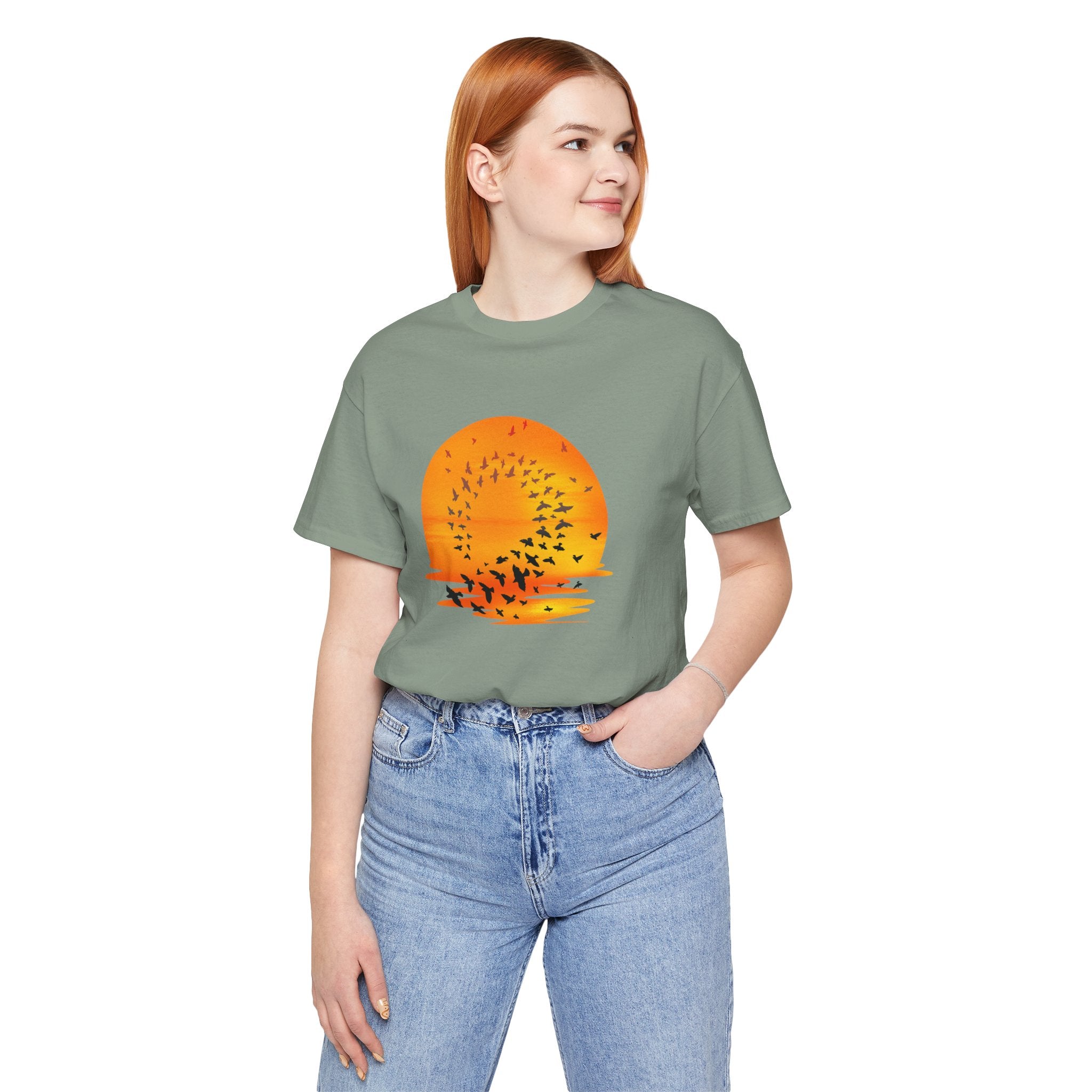 Person wearing a green t-shirt with an orange graphic design on a white background