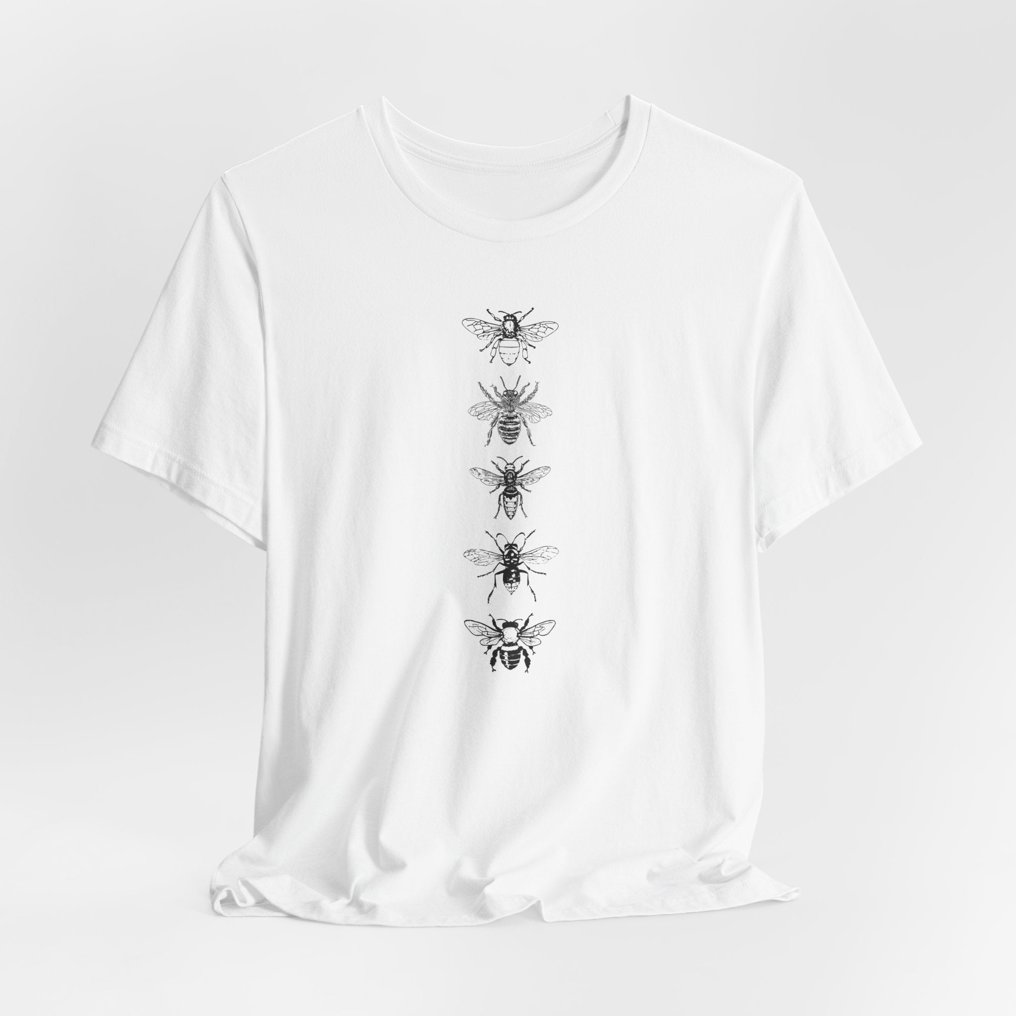 White t-shirt with black bee illustrations on a white background