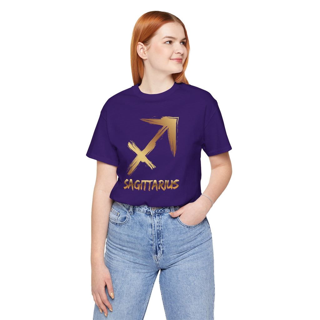Person wearing a purple t-shirt with a gold Sagittarius symbol and text on a white background