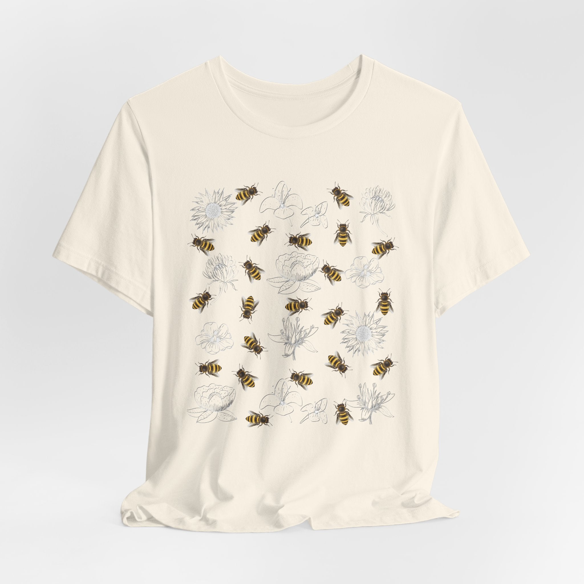 Beige t-shirt with bee and flower pattern on a light gray background