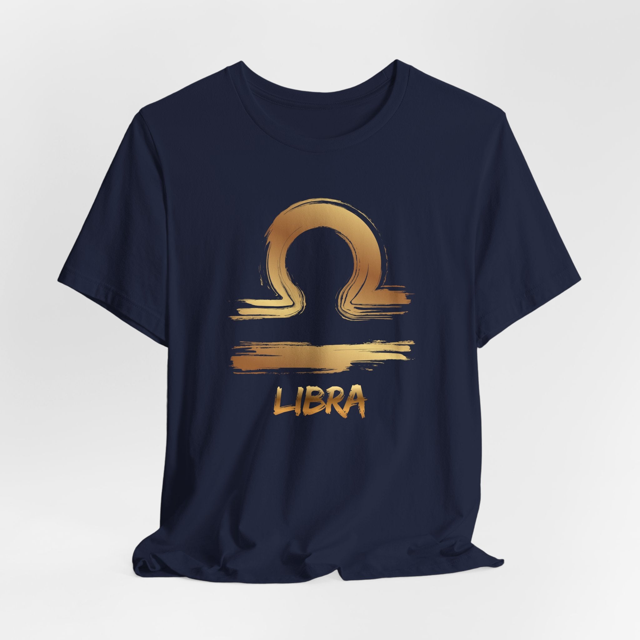 Navy blue t-shirt with gold Libra zodiac symbol on a light gray background