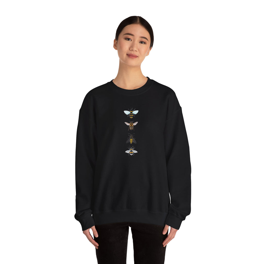 Person wearing a black sweatshirt with bee illustrations on a white background