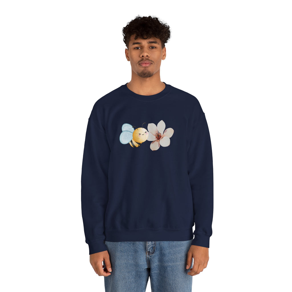 Person wearing a navy blue sweatshirt with bee and flower pattern on a white background